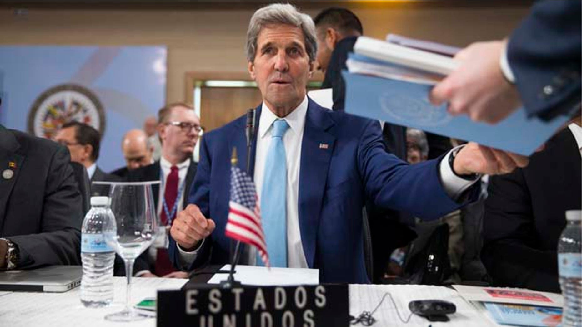 Secretary of State John Kerry is handed notes as he sits down for the General Assembly of the Organization of American States, Tuesday, June 14, 2016, in Santo Domingo, Dominican Republic. (AP Photo/Evan Vucci, Pool)