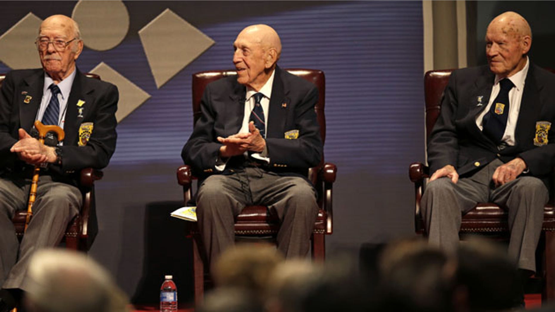 November 9, 2013: Three of the four surviving members of the 1942 Tokyo raid led by Lt. Col. Jimmy Doolittle, left to right, Edward Saylor, Richard Cole, and David Thatcher, applaud a speaker during their final toast celebration at the National Museum of the US Air Force in Dayton, Ohio. The fourth surviving member, Robert Hite, was unable to travel to the ceremonies. (AP Photo/Al Behrman)