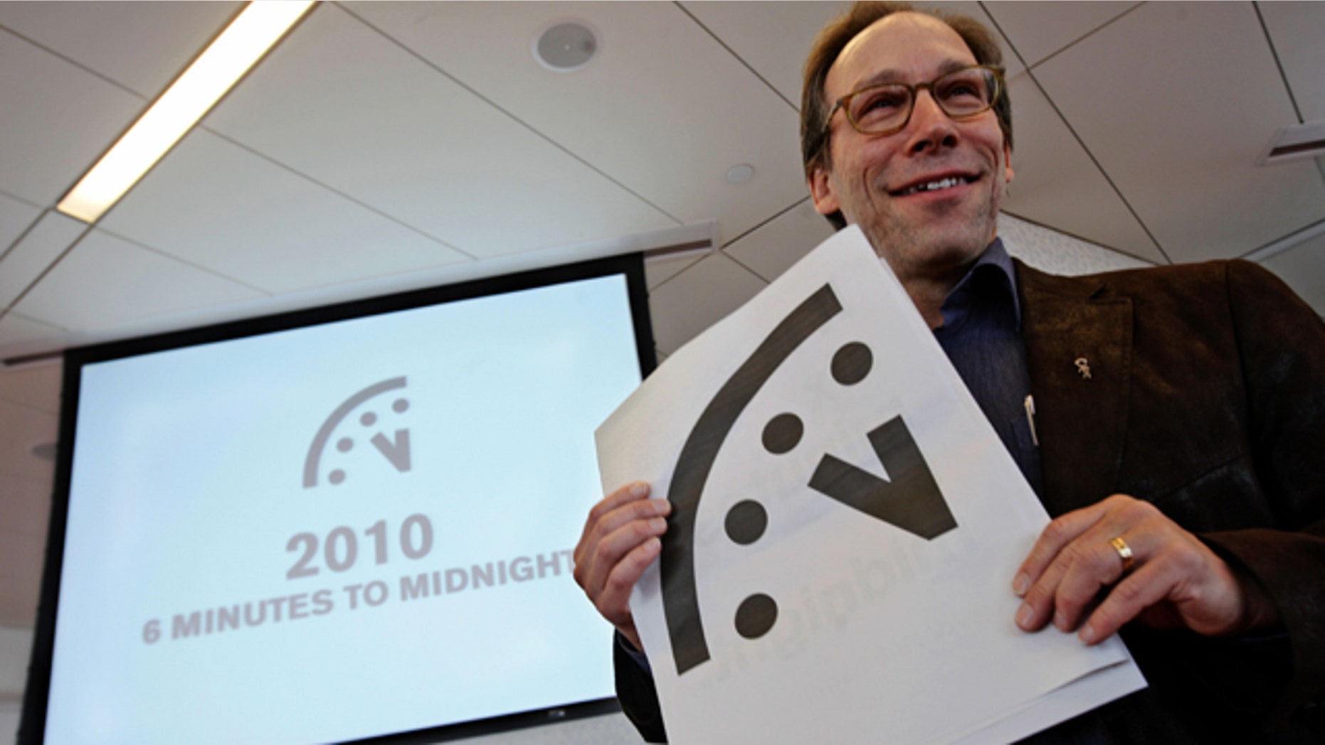 Lawrence Krauss, co-chair of the Bulletin of Atomic Scientists Board of Sponsors poses with a graphic image of the "Doomsday Clock" during a news conference.