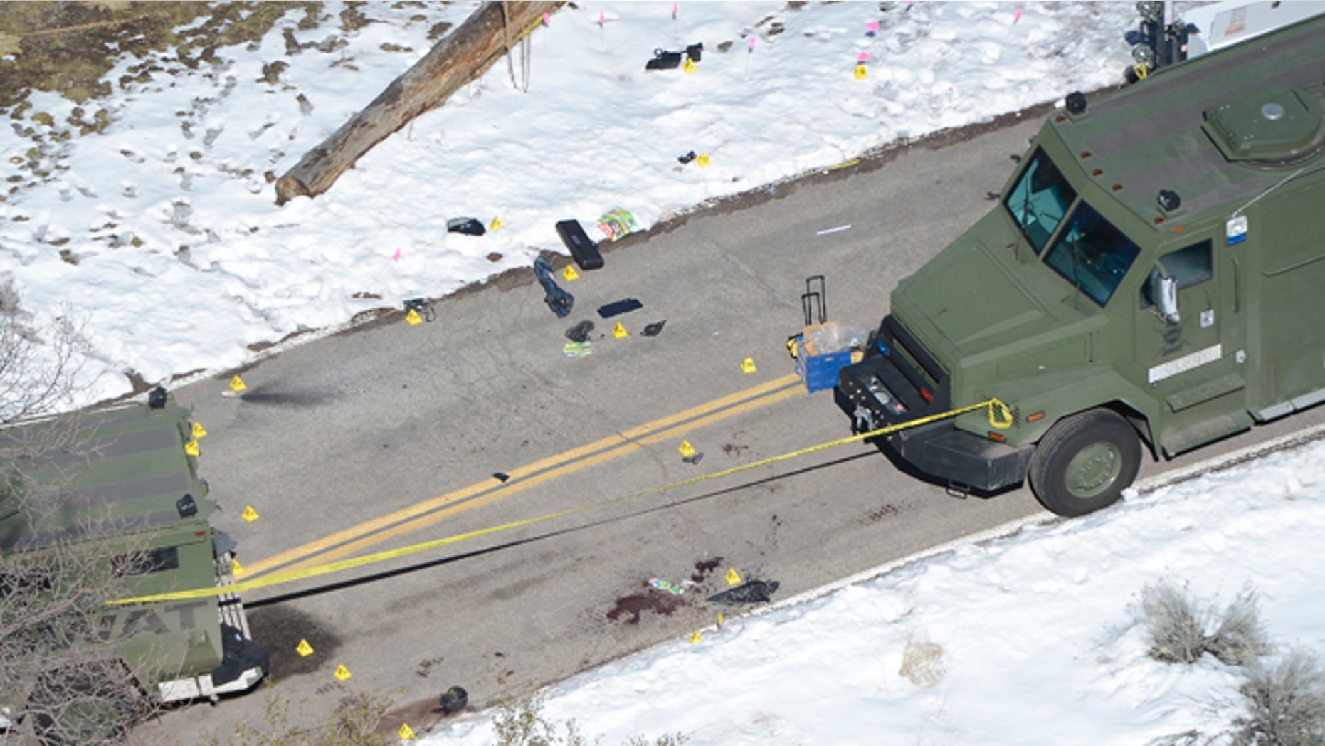 Feb. 13, 2013: Markers and blood stains are seen on a street near a burnt out cabin near Angelus Oaks, California where police believe they engaged in a shootout with fugitive former Los Angeles police officer Christopher Dorner on Tuesday.