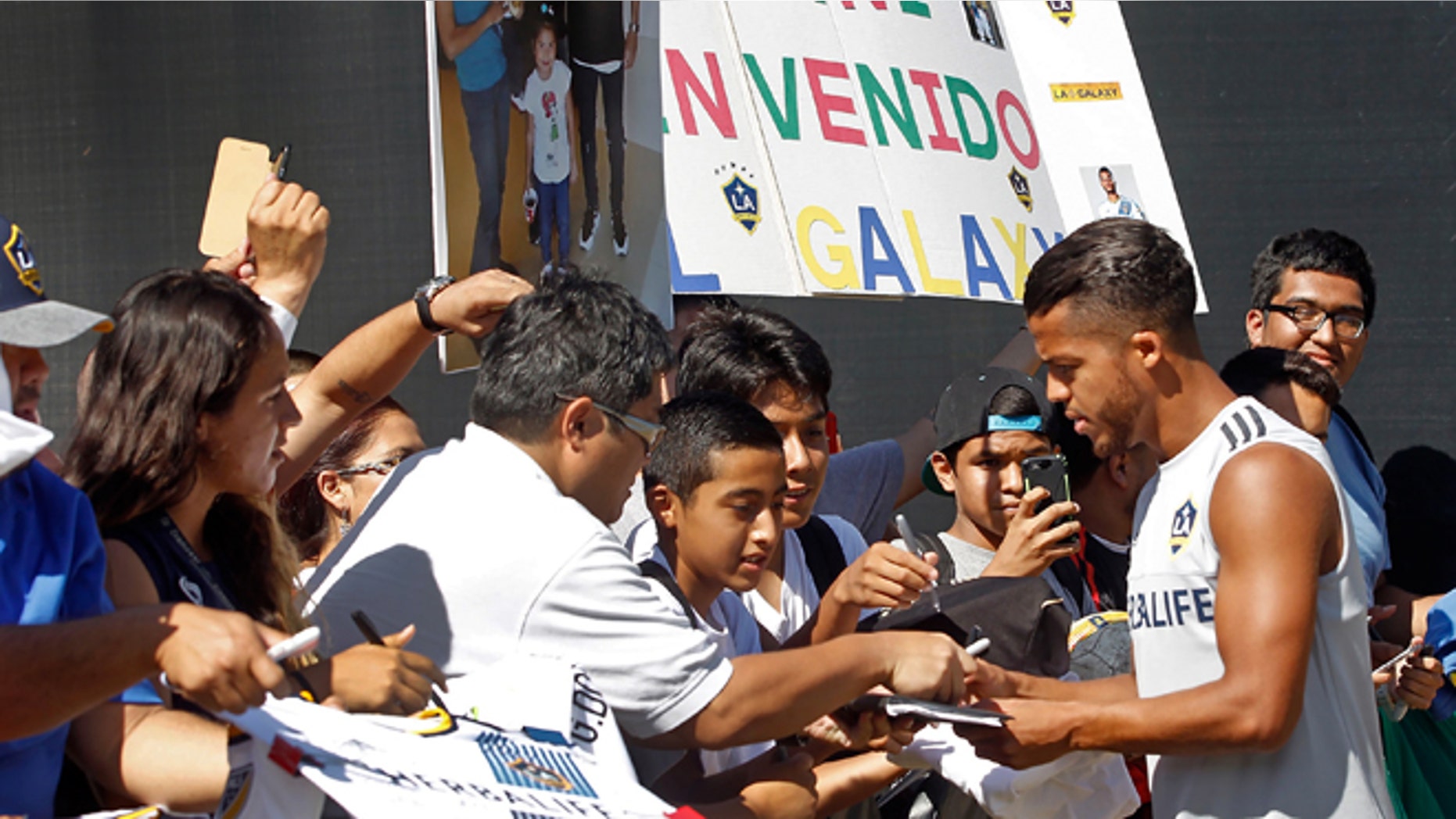 Los Angeles Galaxy forward Giovani dos Santos signs autographs before his first training with the MLS soccer team in Carson, Calif., on Tuesday, Aug. 4, 2015. After four years of courting dos Santos, the Galaxy signed the highest-profile Mexican star in their history to a designated player contract, paying a reported $7 million transfer fee. He will make his Major League Soccer debut on Sunday against the Seattle Sounders FC. (AP Photo/Nick Ut)