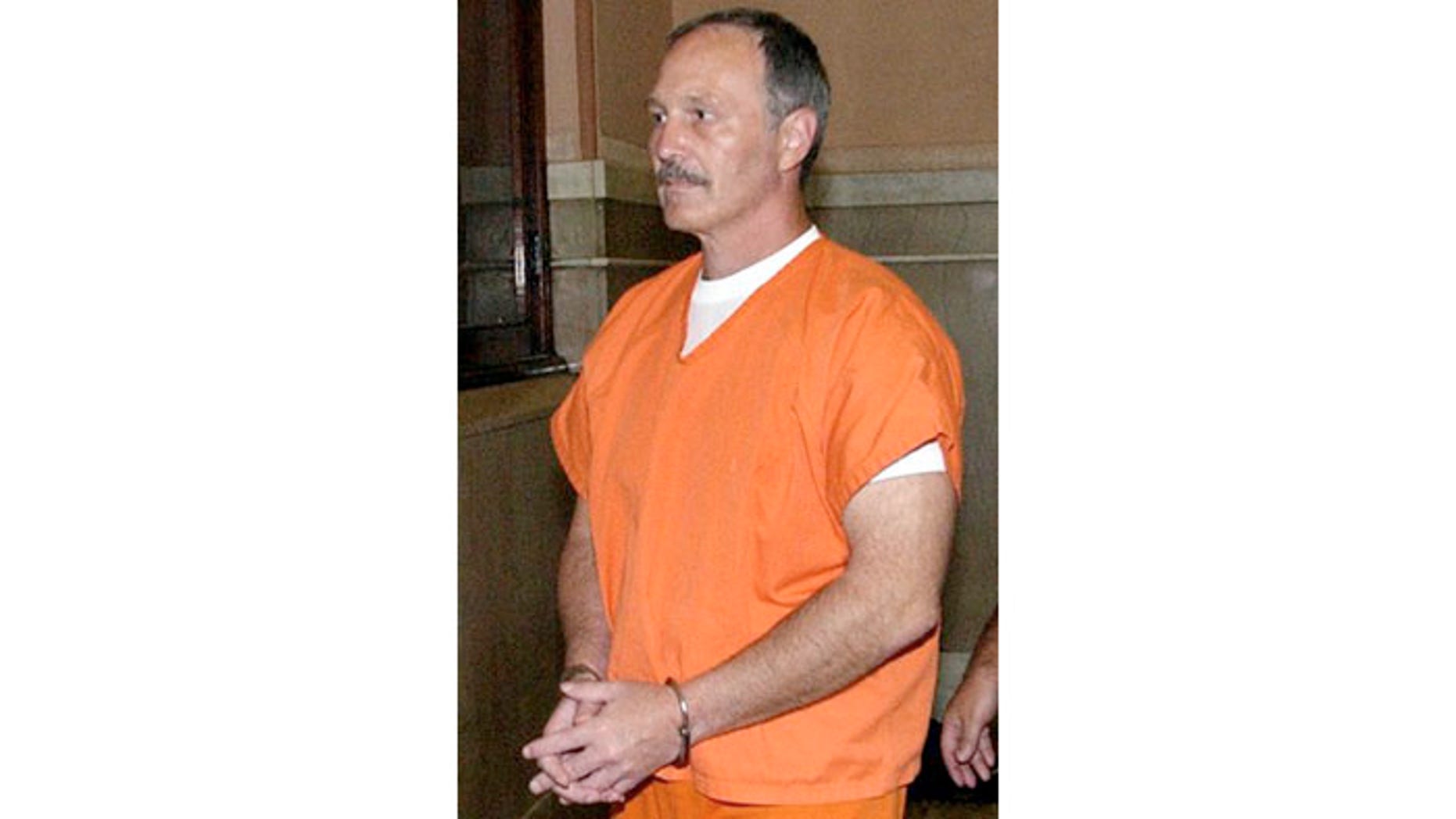 August 12, 2003: David Munchinski is escorted from the Fayette County Courthouse in Uniontown, Pa.