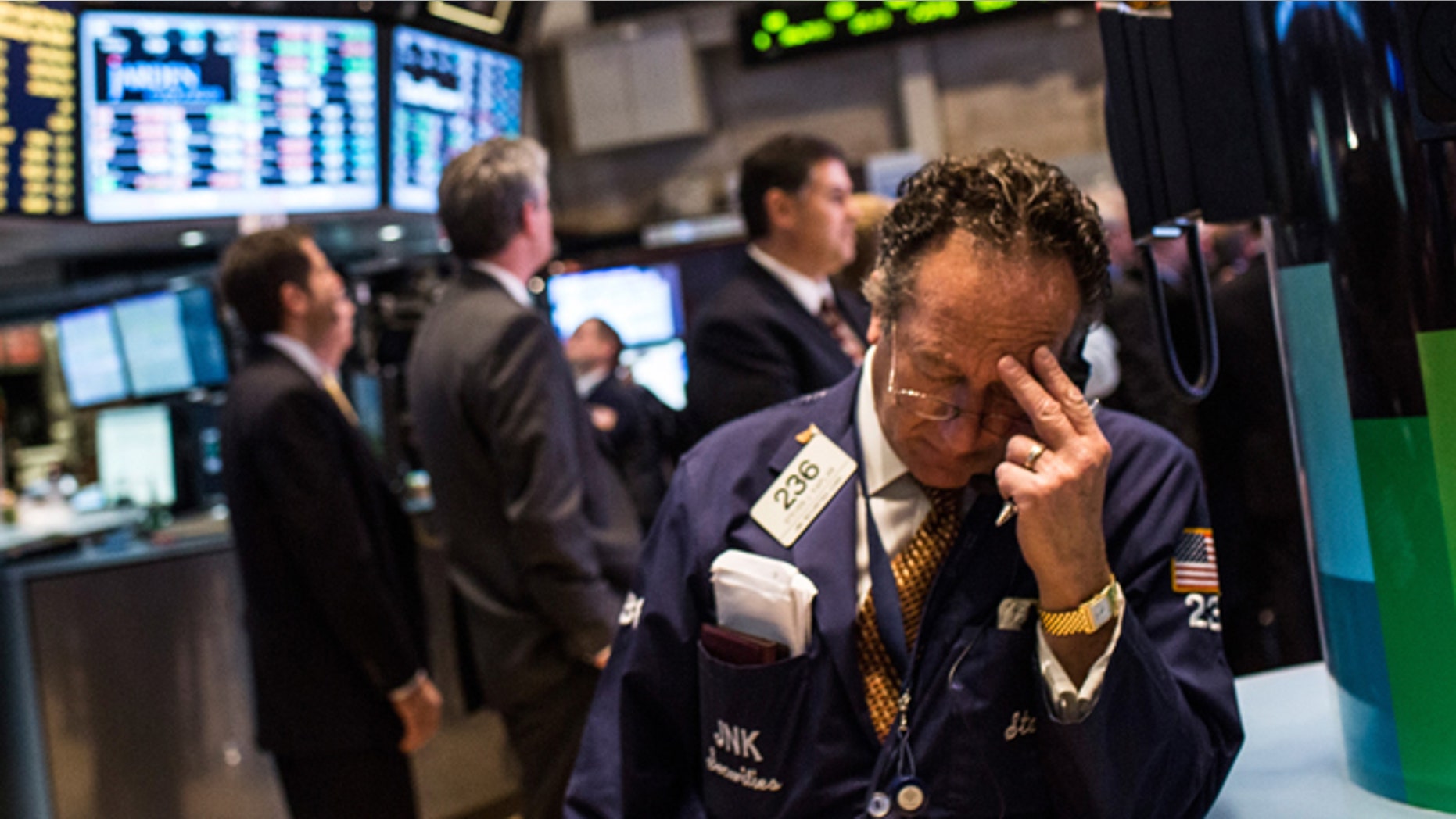 NEW YORK, NY - DECEMBER 04: A trader works on the floor of the New York Stock Exchange on December 4, 2013 in New York City. The Dow Jones Industrial Average dipped over 100 points during trading before bouncing back to approximately 15,900; the market peaked at a record high last month at over 16,000 points. (Photo by Andrew Burton/Getty Images)