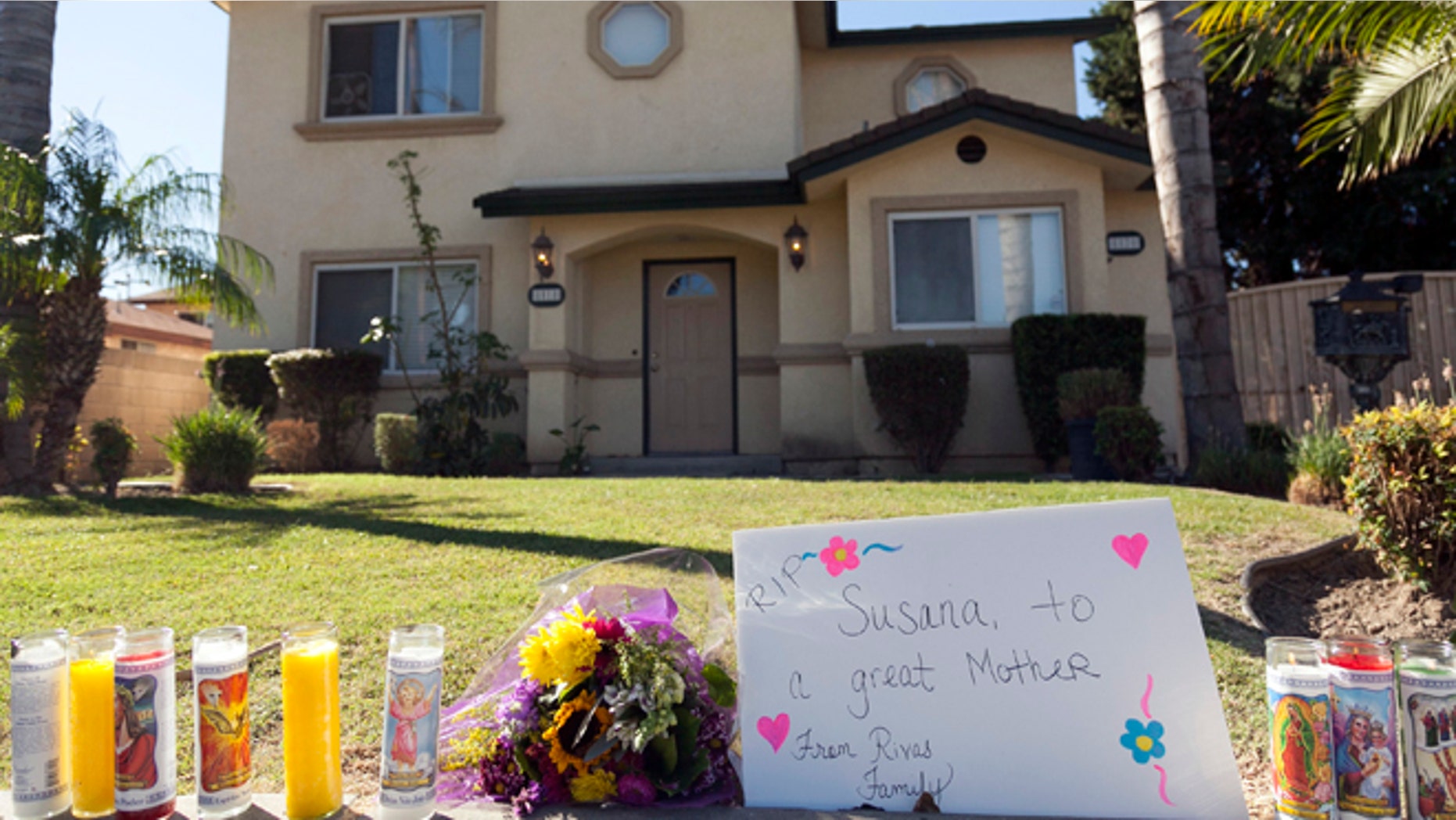 Oct. 25, 2012: Tributes are seen outside the home of a family targeted by a gunman in Downey, Calif.