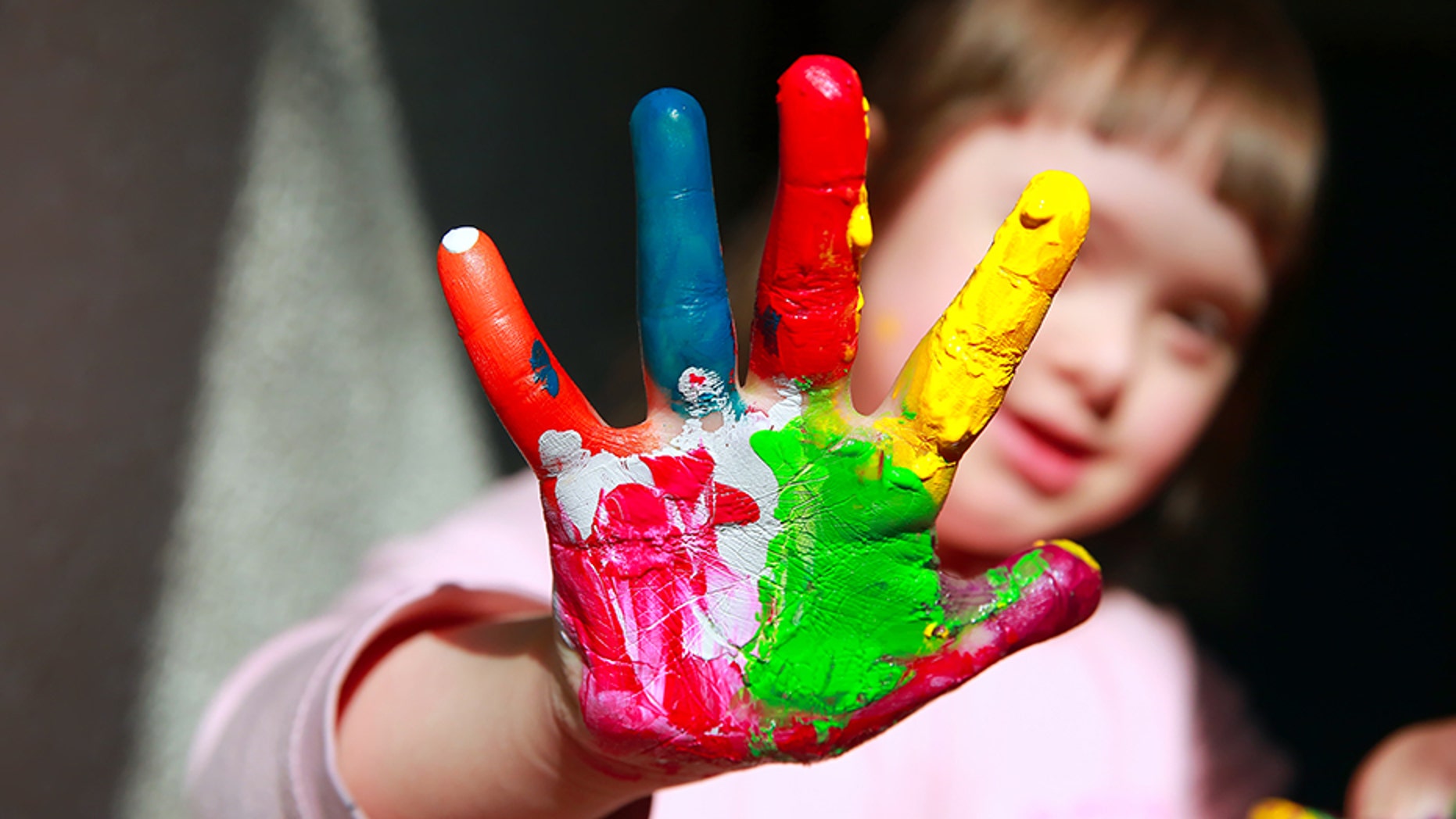 Cute little girl with painted hands