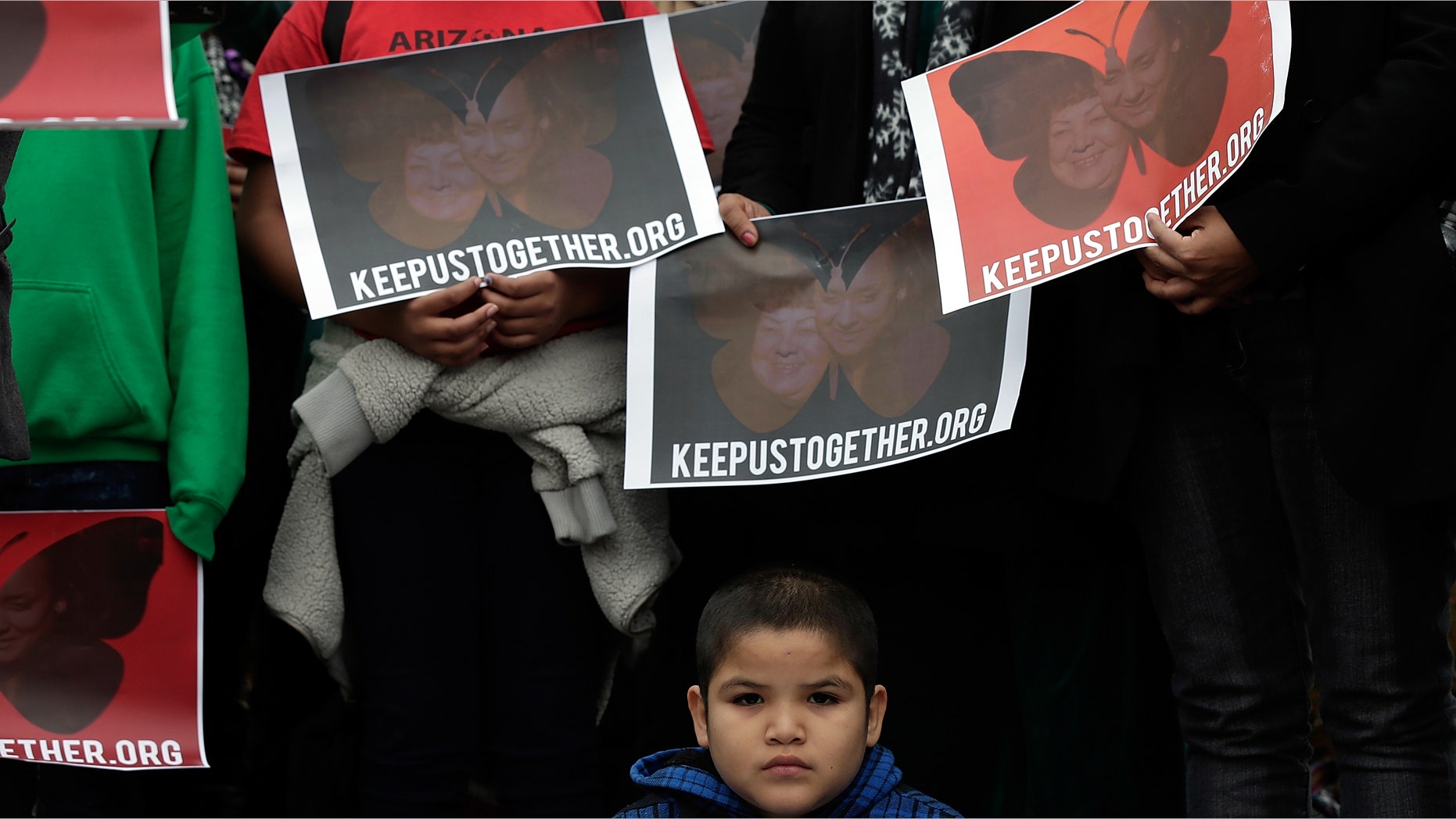 A child listens at a press conference held by the Dream Action Coalition on immigration reform on December 4, 2013 in Washington, DC. (Photo by Win McNamee/Getty Images)