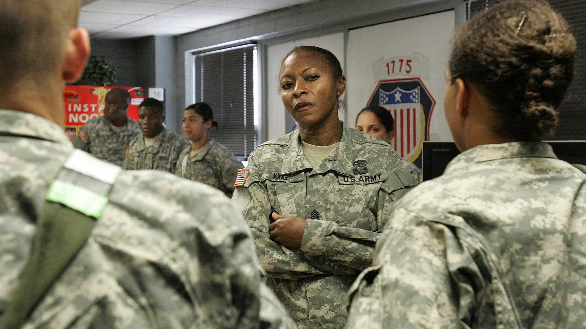 Sept. 15, 2009: Command Sgt. Maj. Teresa King, 48, queries young soldiers during an inspection of the barracks at Fort Jackson, S.C.