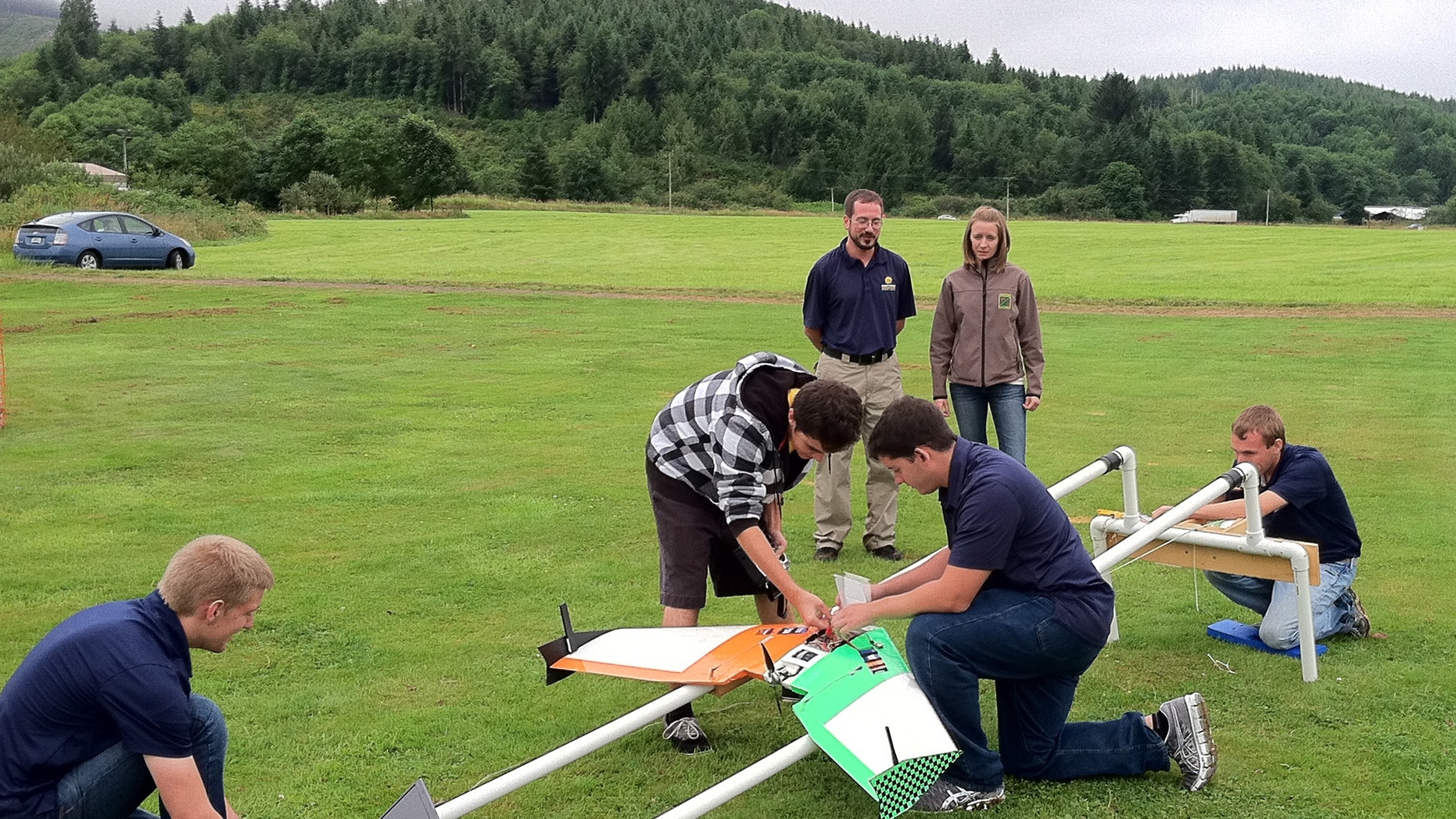 July 26, 2012: This photo provided by Embry-Riddle Aeronautical University shows students demonstrating the launch catapult for their drone aircraft near Tillamook, Ore.