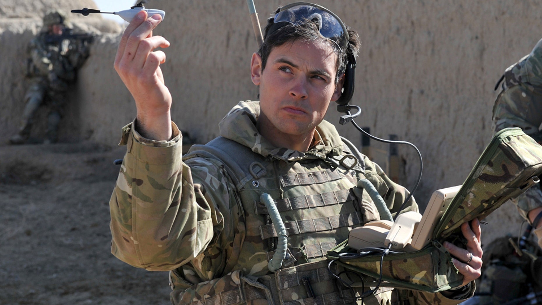 Sergeant Scott Weaver, of The Queens Royal Lancers launches a Black Hornet, Nano UAV from a compound in Afghanistan.