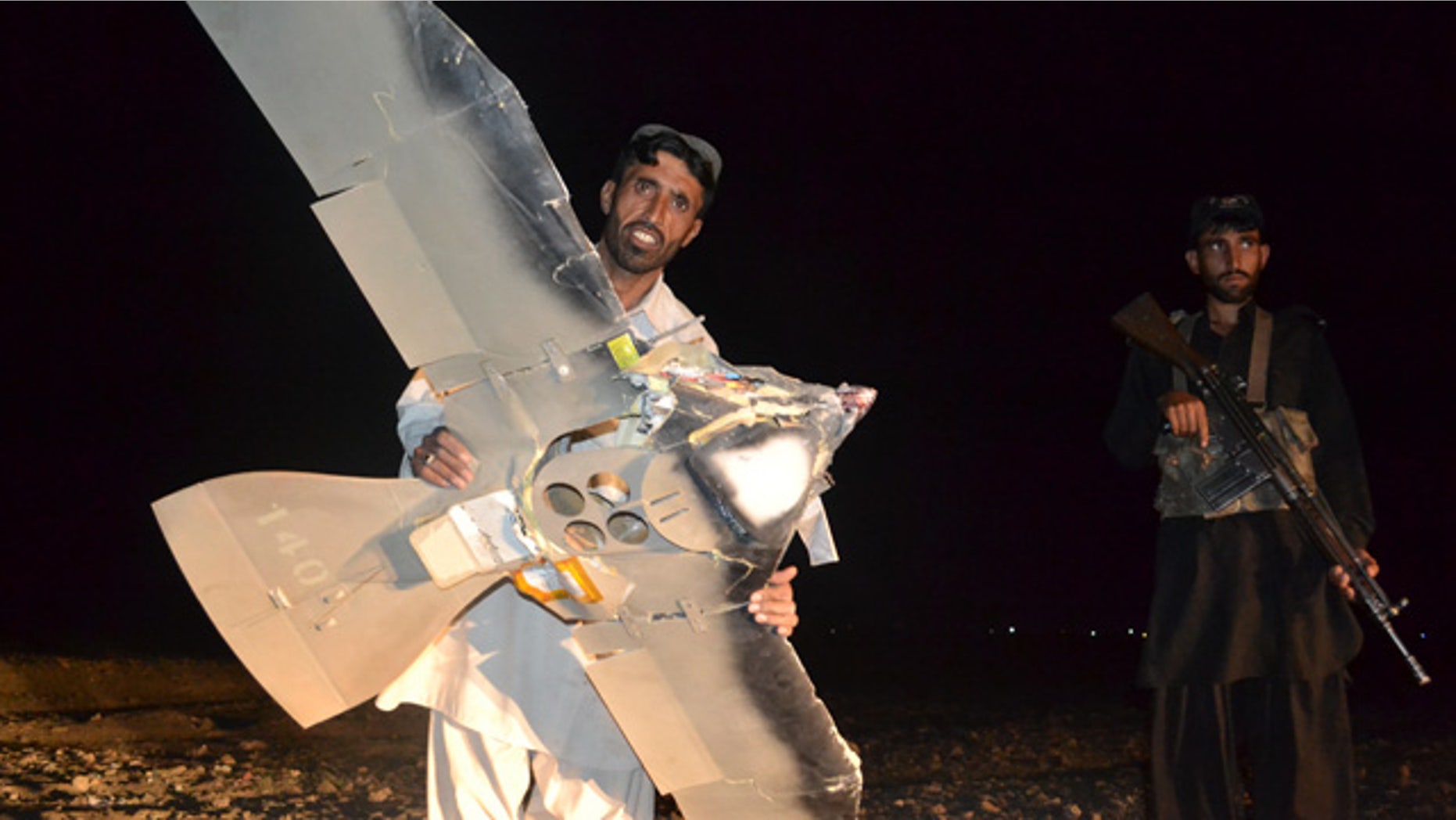 Aug. 25: A Pakistani villager holds a wreckage of a suspected surveillance drone that crashed in Pakistani border town of Chaman along the Afghanistan border.