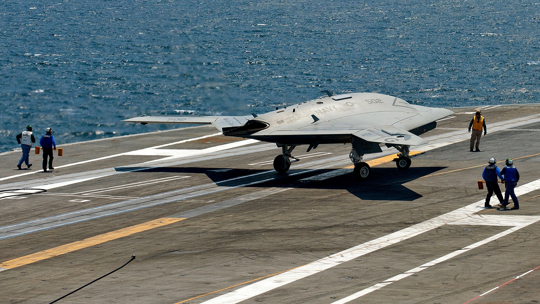 July 10, 2013: An X-47B pilot-less drone combat aircraft comes to a stop after landing on the deck of the USS George H.W. Bush aircraft carrier in the Atlantic Ocean off the coast of Norfolk, Virginia .