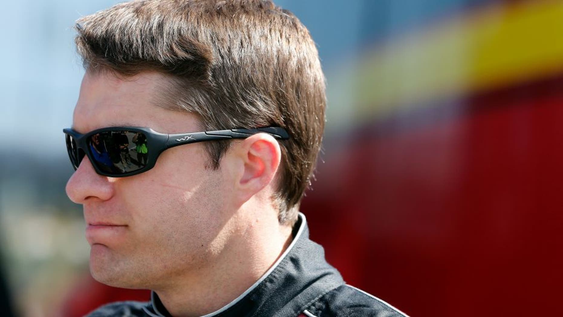DAYTONA BEACH, FL - FEBRUARY 20: David Ragan, driver of the #23 Dr Pepper Toyota, stands in the garage area during practice for the NASCAR Sprint Cup Series Daytona 500 at Daytona International Speedway on February 20, 2016 in Daytona Beach, Florida. (Photo by Brian Lawdermilk/Getty Images)