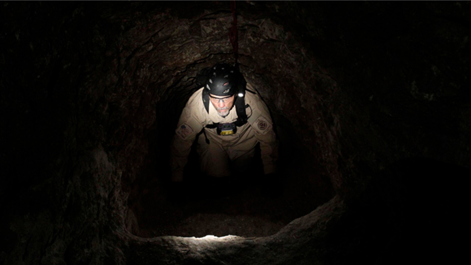 A U.S. Immigration and Customs Enforcement agent climbs in a drug tunnel in San Diego on Dec. 2, 2010. Tunnels are a commonly used method to transport drugs from Mexico to the U.S.