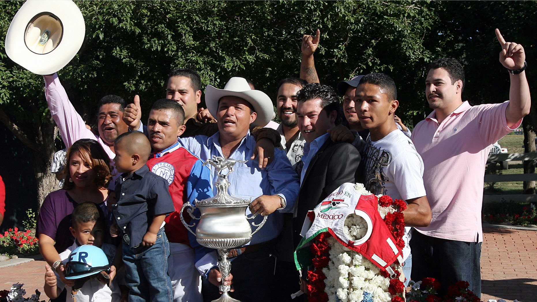 Jose Trevino Morales, center, acknowledges the crowd in 2010 after Mr. Piloto won the All-American Futurity horse race at Ruidoso Downs, N.M.