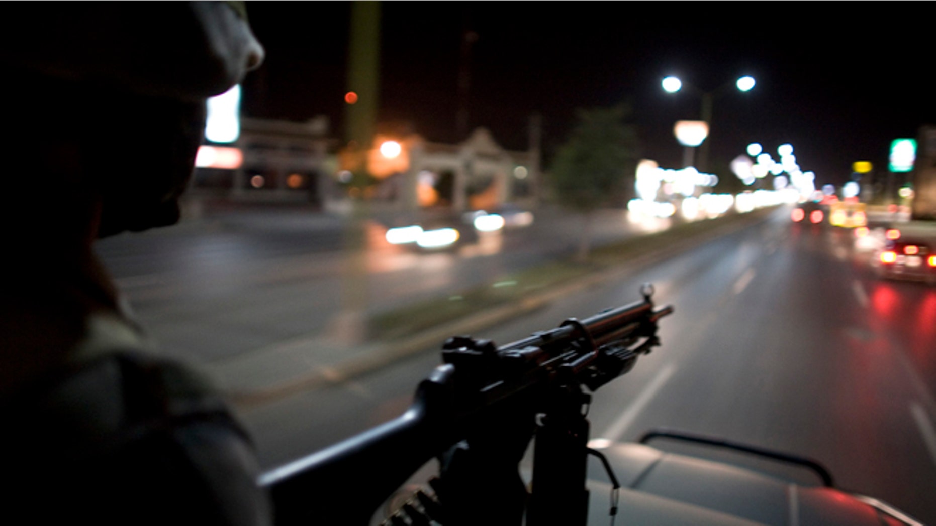 FILE - In this March 17, 2009 file photo, Mexican soldiers patrol the streets of Reynosa, on Mexico's northeastern border with the United States. On March 10, 2013, heavy gunfire echoed along the main thoroughfare and across several neighborhoods in a firefight that lasted for hours, leaving perforated and burned vehicles scattered across the border city. Social media exploded with reports of dozens dead. Witnesses saw at least 12, but an official count showed only a couple of deaths. (AP Photo/Alexandre Meneghini, File)