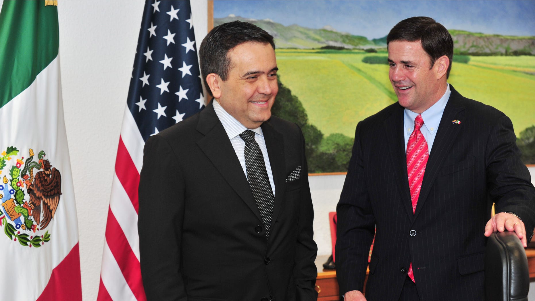 In this June 19, 2015 photo provided by the Office of Governor Doug Ducey, the Arizona governor, right, meets with Mexicoâs Secretary of the Economy, Ildefonso Guajardo Villarreal, also a graduate of Arizona State University, during Ducey's visit to Mexico City. It was Ducey's first trip to Mexico since his inauguration in January. (Victor Abreu/Office of Governor Doug Ducey, via AP)