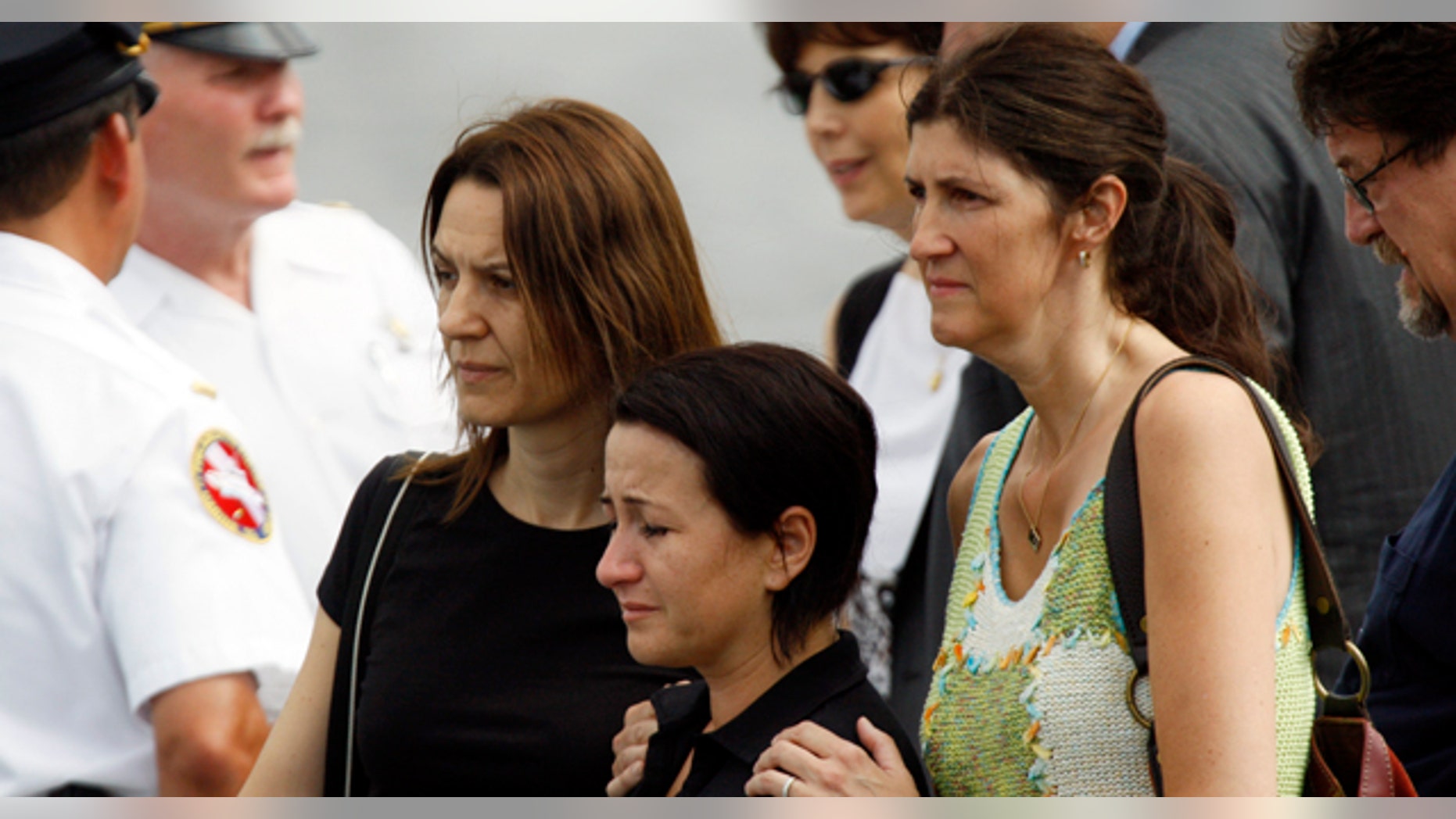 July 8: Two Hungarian teachers, who survived a duck boat crash on Wednesday, are consoled by a U.S. woman, who served as a host for a Hungarian student group, as they view the site where two of their students went missing on the Delaware River in Philadelphia. (AP)