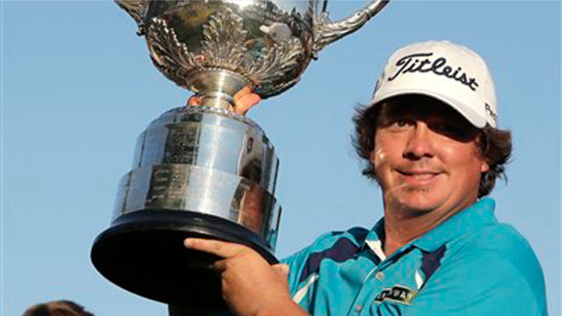 Aug. 11, 2013: Jason Dufner holds up the Wanamaker Trophy after winning the PGA Championship golf tournament at Oak Hill Country Club.