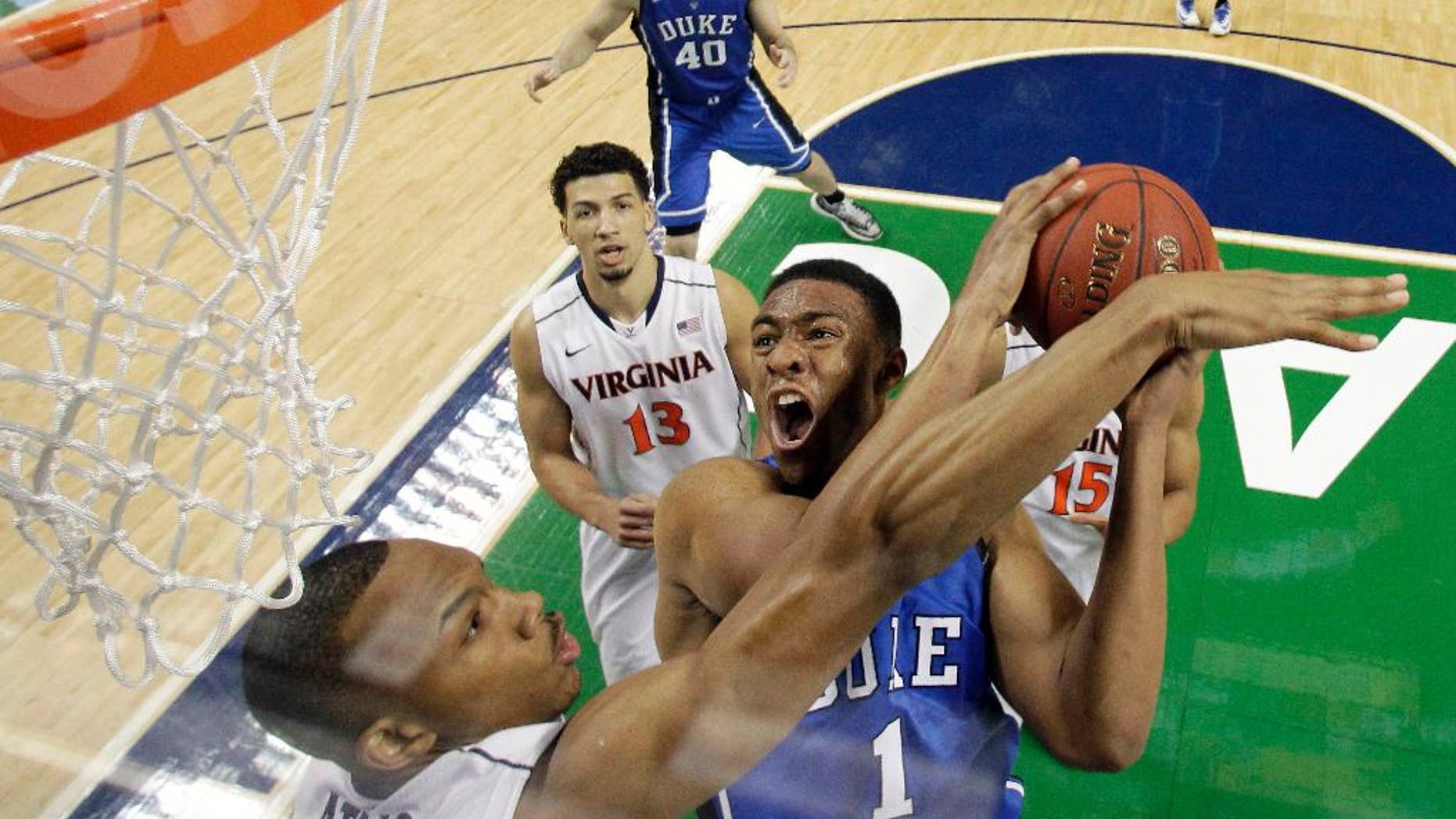 FILE - In this March 16, 2014 file photo, Duke's Jabari Parker (1) tries to shoot over Virginia's Darion Atkins during the first half of an NCAA college basketball game in the championship of the Atlantic Coast Conference tournament in Greensboro, N.C. Parker says he plans to meet with Duke coach Mike Krzyzewski when he returns to Durham, N.C., on Tuesday, April 15, 2014, and he will decide Wednesday whether to declare for the NBA draft or return to college for his sophomore year. (AP Photo/Bob Leverone, File)