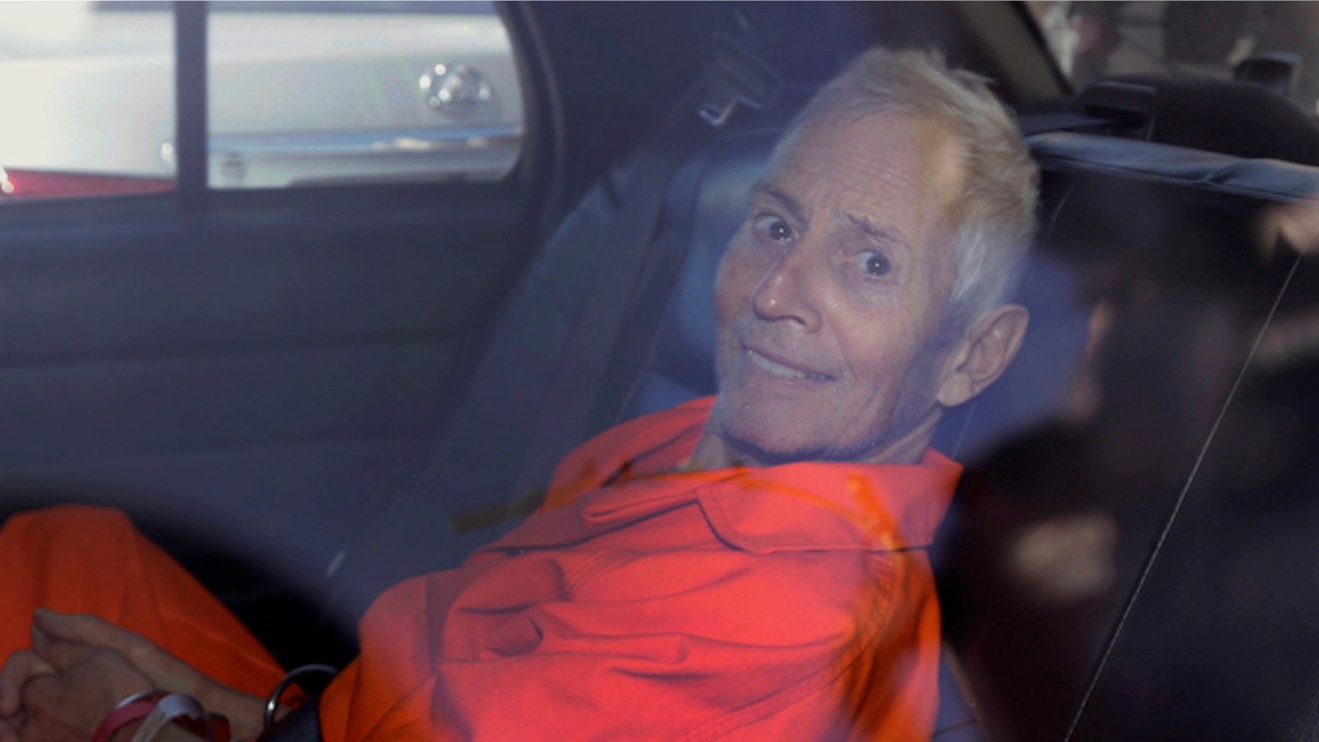 FILE - In this Tuesday, March 17, 2015, file photo, Robert Durst is transported from Orleans Parish Criminal District Court to the Orleans Parish Prison after his arraignment in New Orleans. The whispered words of Durst recorded in an unguarded moment in a bathroom could come back to haunt him - or help him - as he faces a murder charge. A possible move by prosecutors to introduce the incriminating material from a six-part documentary on his strange life and connection to three killings could back fire as interview footage did in the Michael Jackson molestation trial and the Robert Blake murder case. (AP Photo/Gerald Herbert, File)