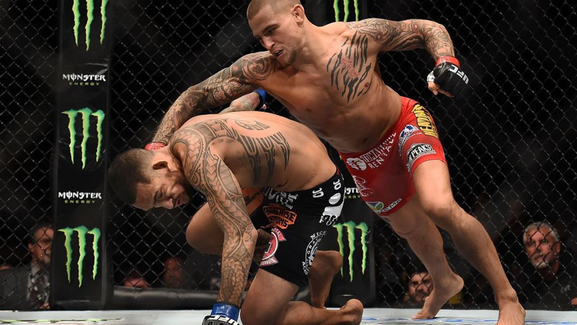 NEW ORLEANS, LA - JUNE 06: Dustin Poirier punches Yancy Medeiros in their lightweight bout during the UFC Fight Night event at Smoothie King Center on June 6, 2015 in New Orleans, Louisiana. (Photo by Stacy Revere/ Zuffa LLC/Zuffa LLC via Getty Images)