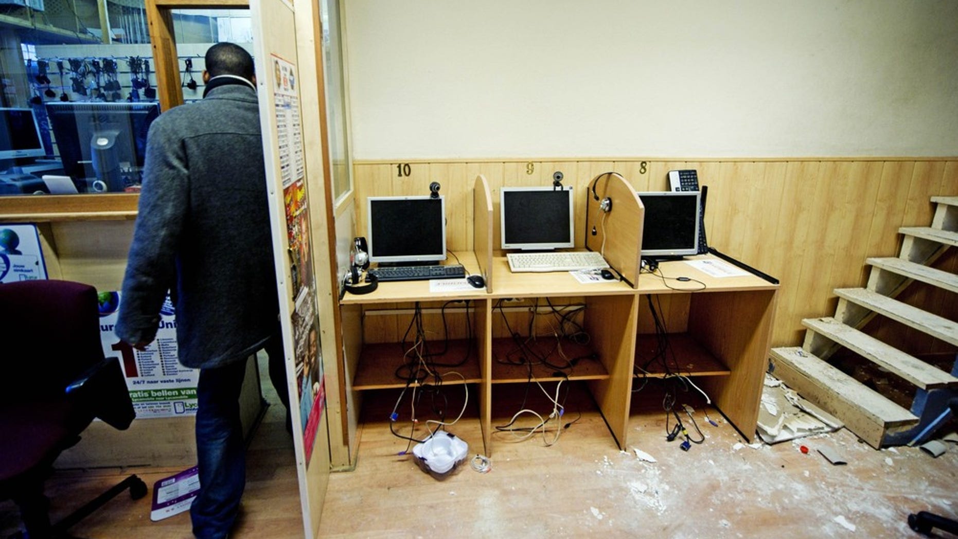 Dec. 25, 2010: The owner of the Banadir telecom center in Rotterdam, stands in his shop after Dutch authorities searched the place as they investigate following the arrests of twelve Somalis suspected of involvement in terrorist activities.