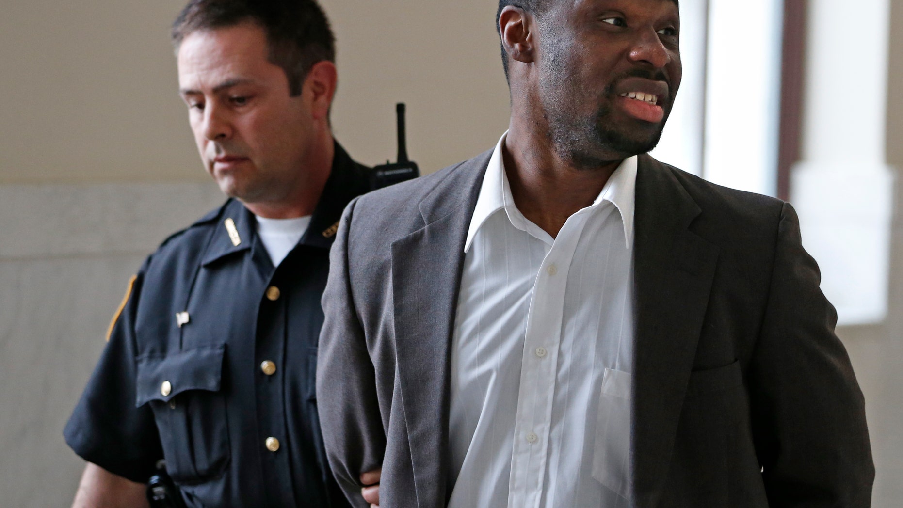 April 16, 2013: This photo in Cincinnati shows Ricardo Woods being taken from court after he was found guilty in the shooting death of a man who authorities say identified his assailant by blinking his eyes while paralyzed.