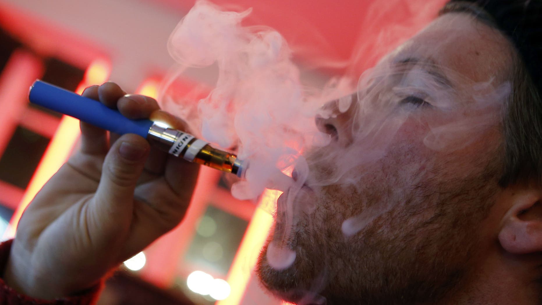 A customer puffs on an e-cigarette at the Henley Vaporium in New York City.