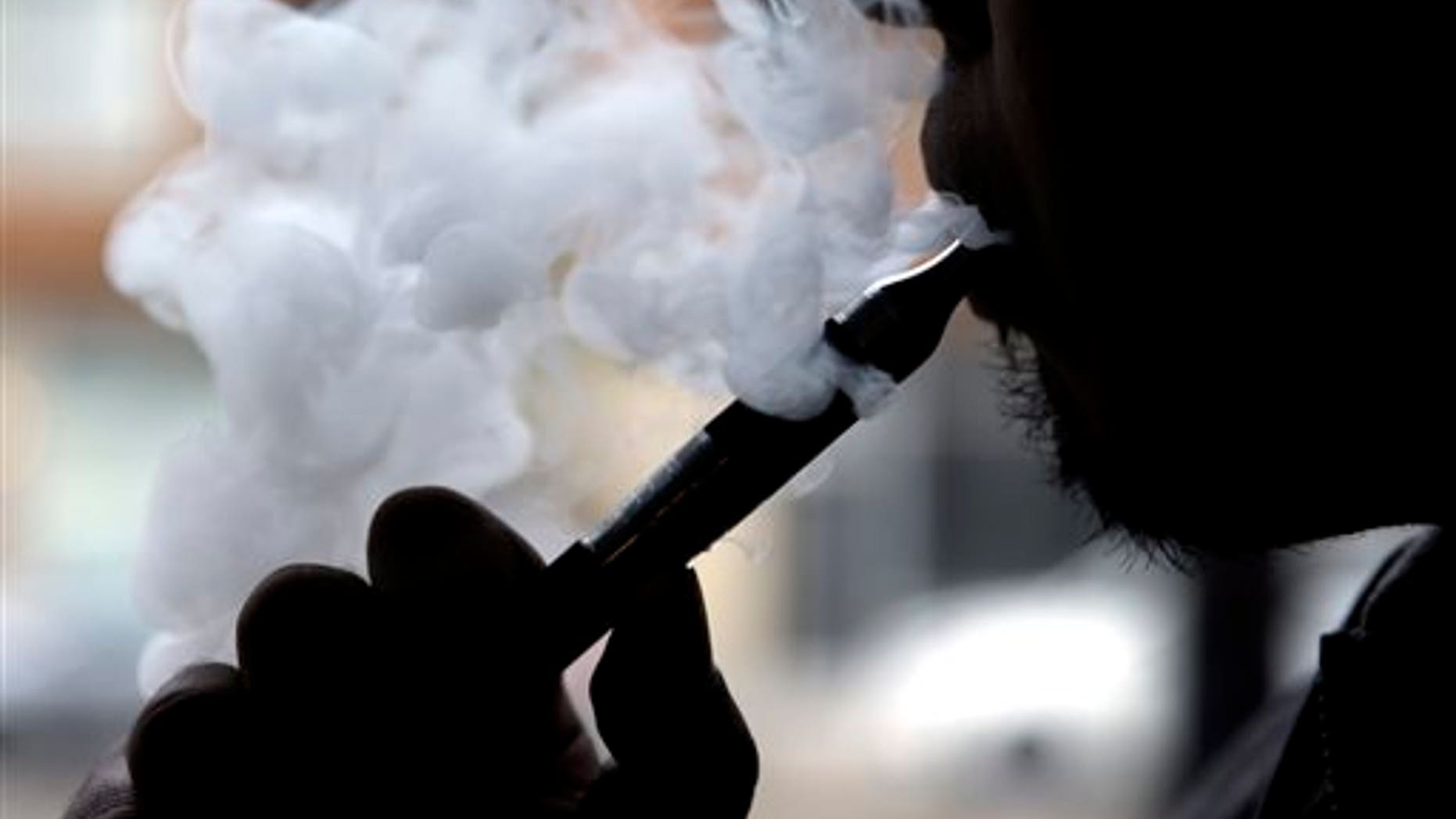 FILE - In this April 23, 2014, file photo, an electronic cigarette is demonstrated in Chicago. In a surprising new policy statement, the American Heart Association backs electronic cigarettes as a last resort to help smokers quit. (AP Photo/Nam Y. Huh, File)