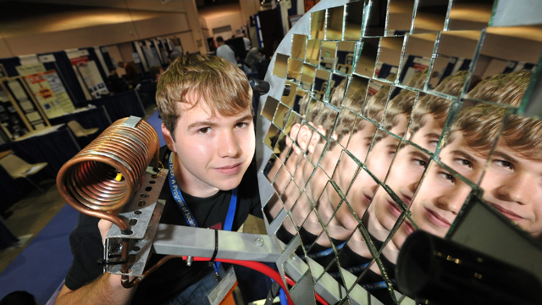 May 16, 2011: Seth Fisher, 16, from Bernville, Pa., demonstrates his solar heat concentrator at the Intel International Science and Engineering Fair, the world’s largest pre-college science competition, in Reno, Nev.