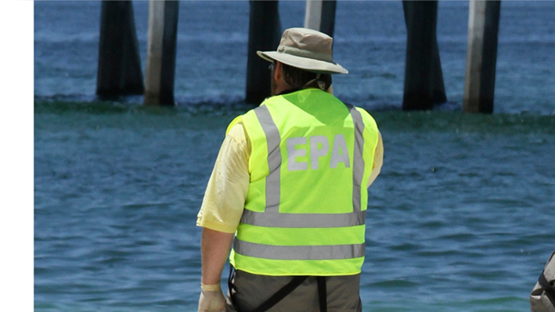 FILE: 2010: An EPA worker monitoring a beach in Pensacola, Florida.