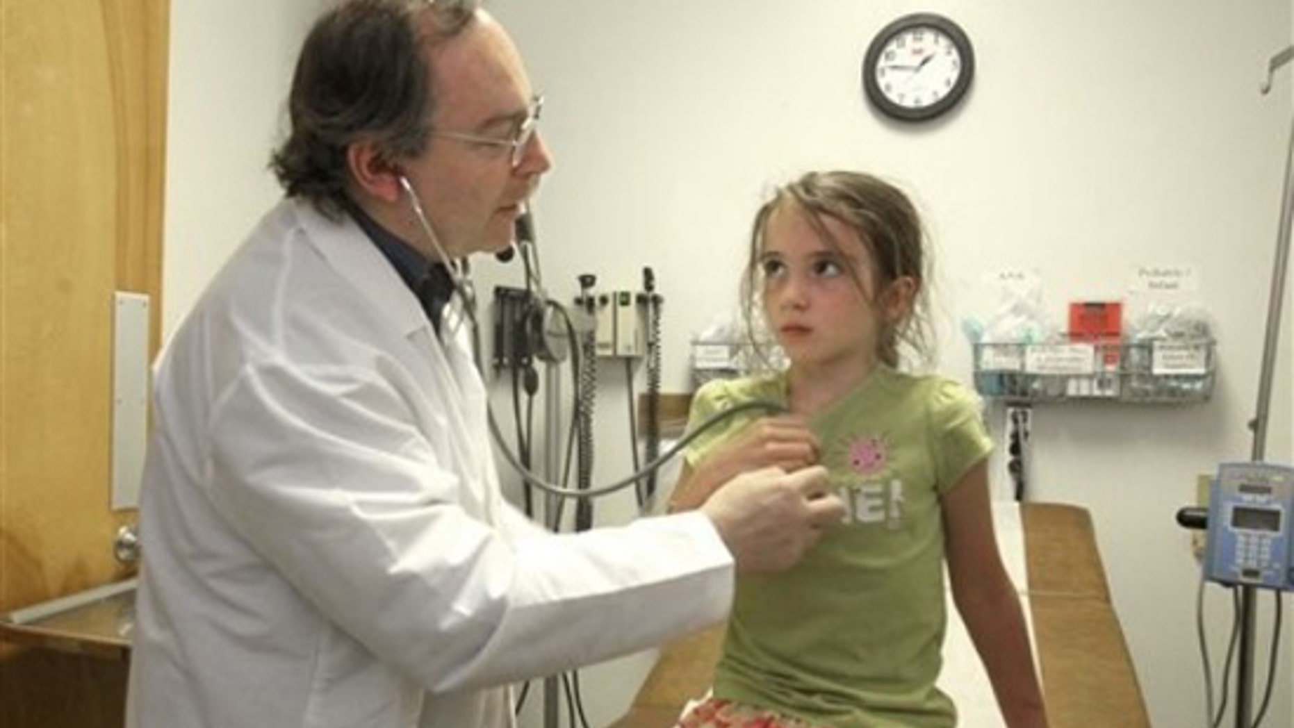In this July 27, 2010 photo, Dr. Martin Kernberg examines Allison Taylor, 7, in the emergency room of the Modoc Medical Center in Alturas, Calif. (AP)