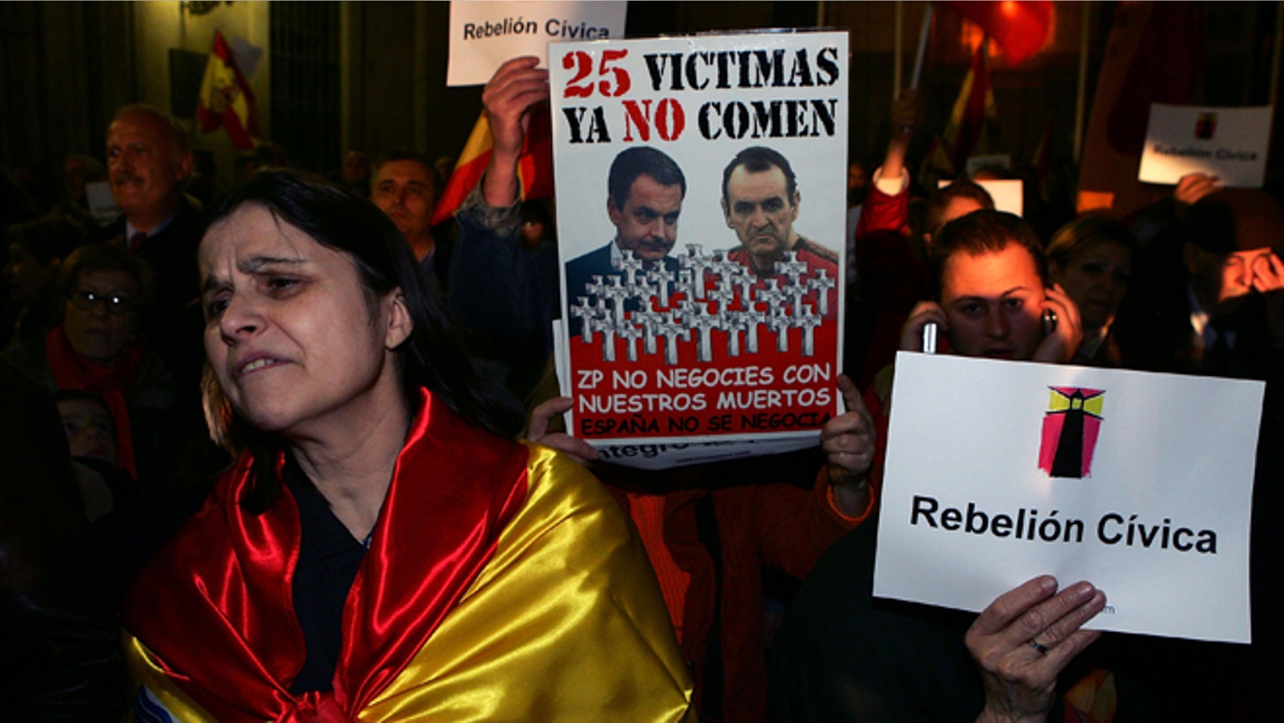 A woman wears the Spanish flag during a protest in front of the Town Hall against the house arrest granted to the hunger striking prisoner Inaki de Juana Chaos on March 2, 2007 in Madrid, Spain. (Photo by Denis Doyle/Getty Images)