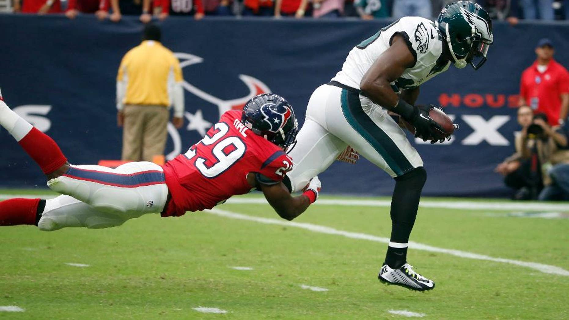 Philadelphia Eagles wide receiver Jeremy Maclin, right, heads to the end zone as Houston Texans defensive back Andre Hal defends after catching a 59-yard pass for a touchdown during the first quarter of an NFL football game, Sunday, Nov. 2, 2014, in Houston. (AP Photo/Tony Gutierrez)
