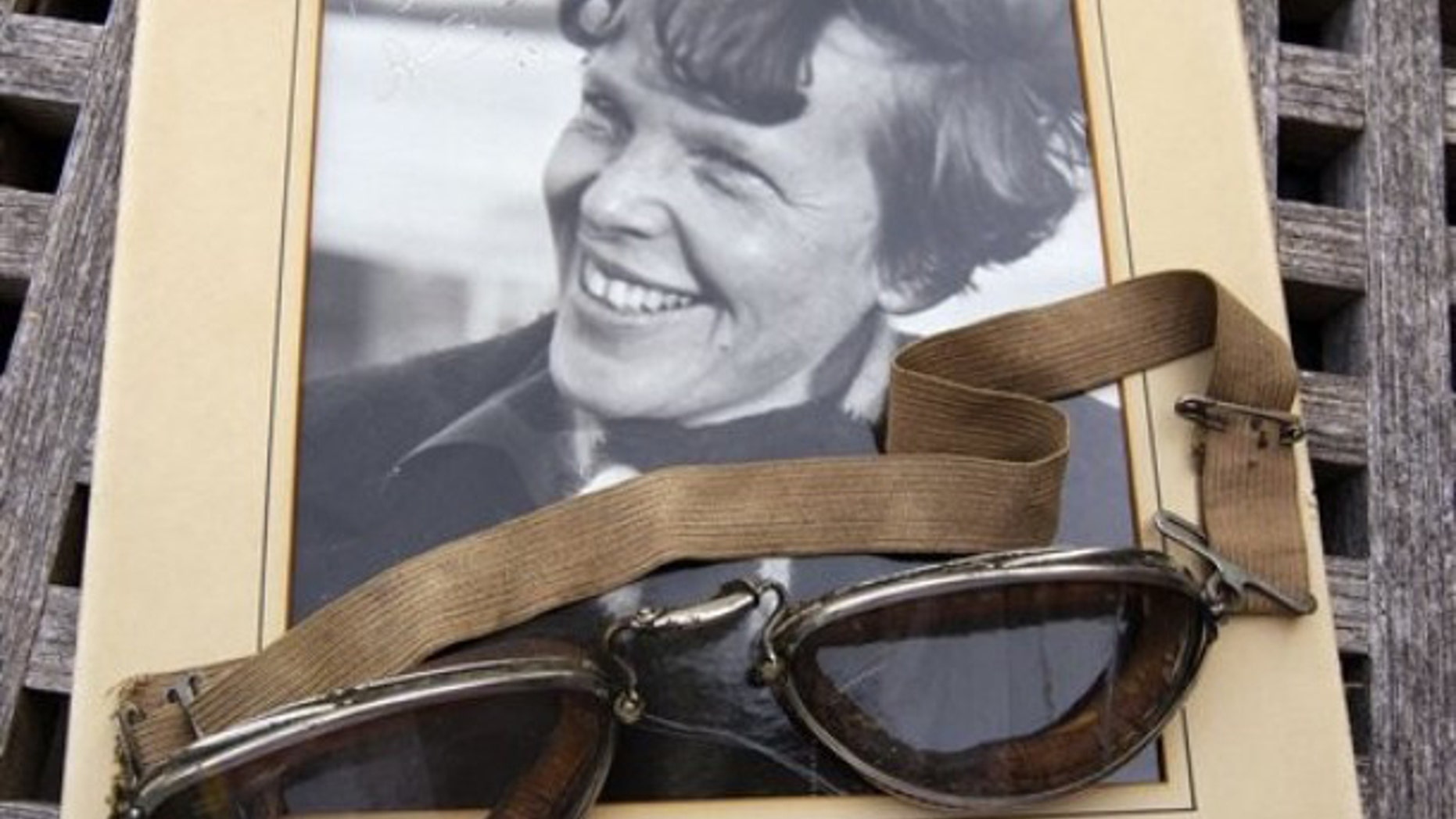 Sept. 9, 2011: An original, unpublished personal photo of Amelia Earhart dated 1937, along with goggles she was wearing during her first plane crash are seen at Clars Auction Gallery in Oakland, Calif. Another set of her goggles sold several years ago for more than $100,000.