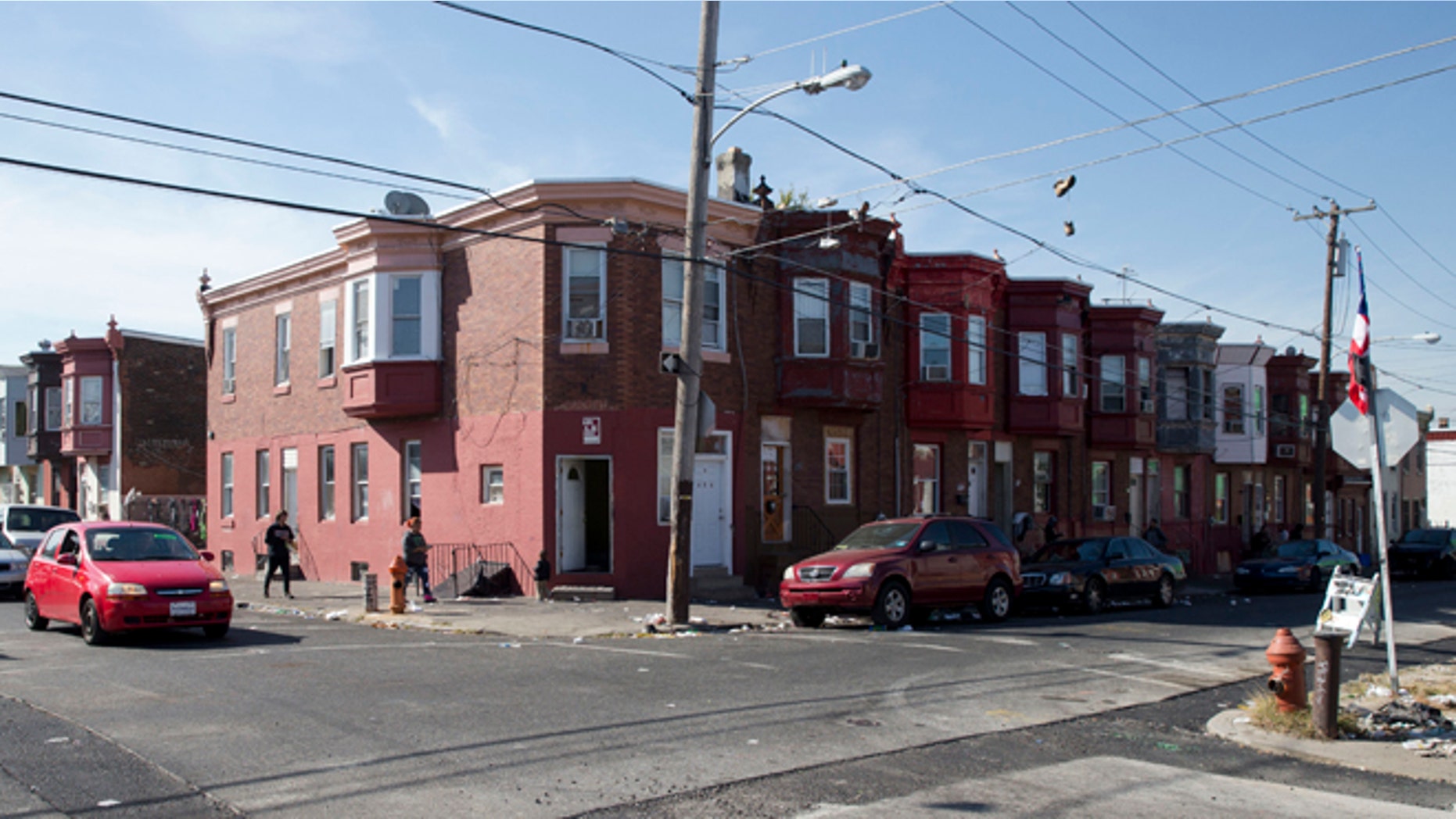 In this Wednesday, Oct. 21, 2015, photo, the intersection of Marshall and Tioga streets in Philadelphia is shown. Drug kingpin Myrna Suren ran a $100,000-a-week cocaine ring centered around this corner in Philadelphia's Hunting Park neighborhood in the 1980s, but is leaving prison soon after her life sentence was cut to 25 years under revised U.S. drug policies. She is one of 6,000 drug offenders leaving prison early this year. (AP Photo/Matt Rourke)