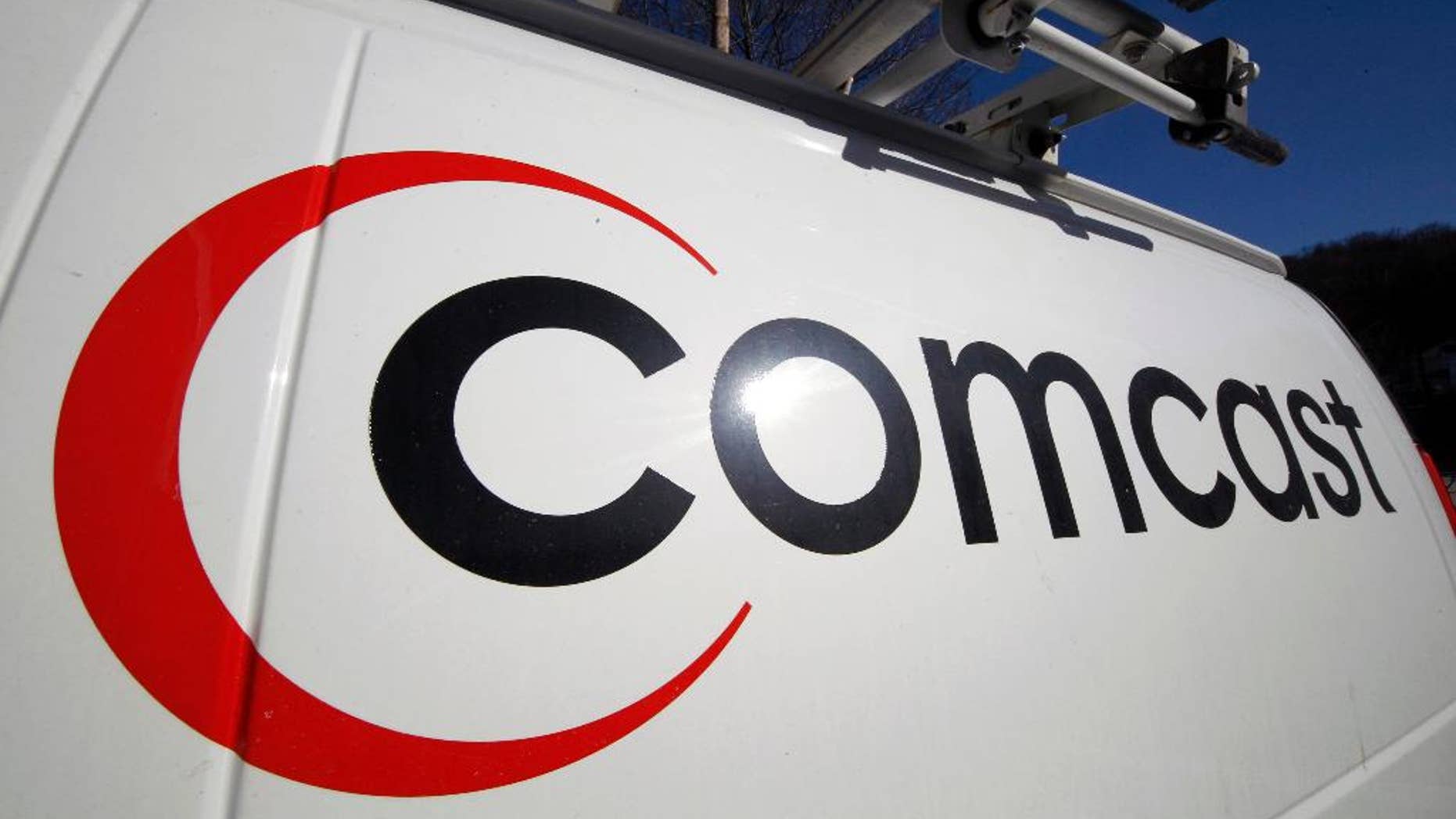 FILE - This Feb. 11, 2011 file photo shows the Comcast logo on one of the company's vehicles, in Pittsburgh. Comcast reports quarterly earnings on Tuesday, April 22, 2014. (AP Photo/Gene J. Puskar, File)