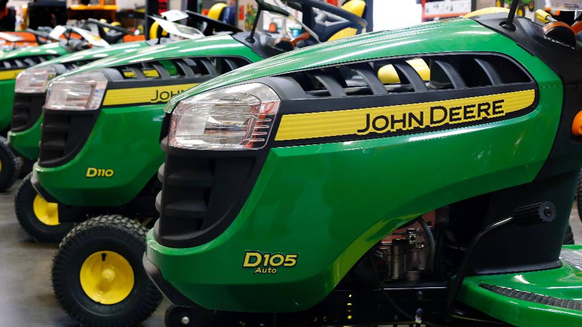 In this March 23, 2015 photo, John Deere lawn tractors are on display at a Home Depot in Robinson Township, Pa. Deere & Co. on Friday, May 22, 2015, reported fiscal second-quarter earnings of $690.5 million. (AP Photo/Gene J. Puskar)