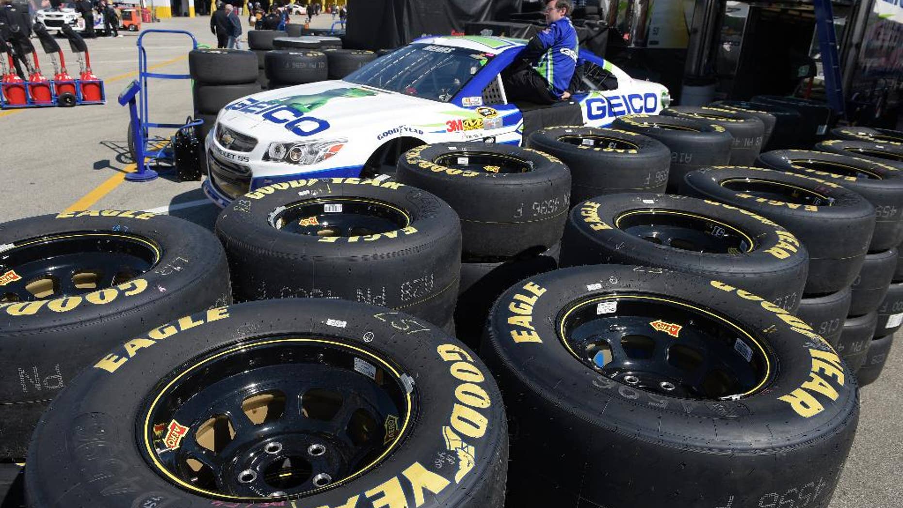 In this Feb. 14, 2015 photo, Goodyear tires surround the Casey Mears car in the garage area during a practice session for the Daytona 500 NASCAR Sprint Cup Series auto race at Daytona International Speedway, in Daytona Beach, Fla. The Goodyear Tire & Rubber Co. reports quarterly financial results on Tuesday, Feb. 17, 2015. (AP Photo/Phelan M. Ebenhack)