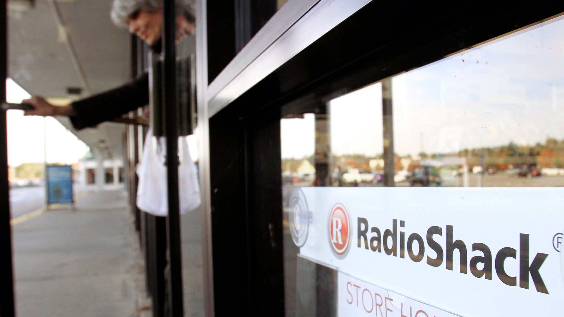 FILE - In this Wednesday, Oct. 20, 2010 photo, a shopper leaves a RadioShack store in Brunswick, Maine. Electronics retailer RadioShack Corp. on Tuesday, March 4, 2014 said it plans to close up to 1,100 of its underperforming stores in the U.S. and reported a wider loss for its fourth quarter as traffic slowed during the critical holiday season. (AP Photo/Pat Wellenbach, File)