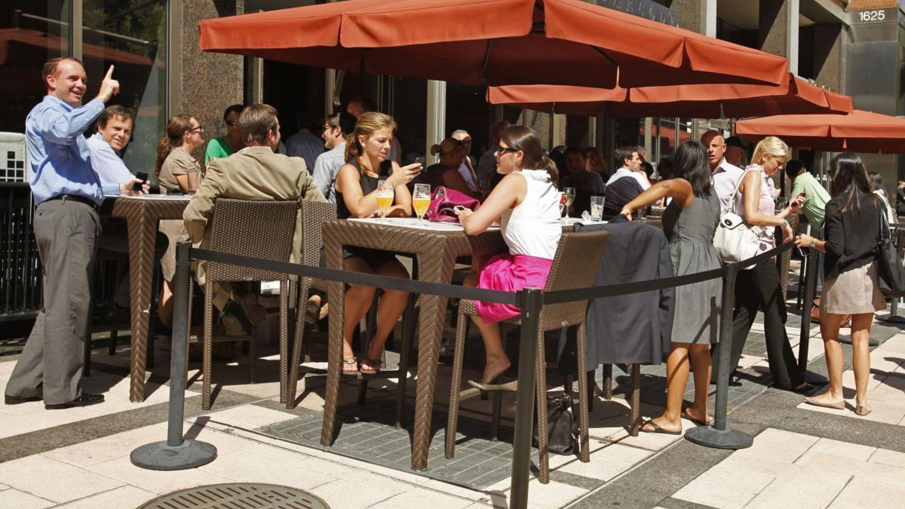 People have drinks at an outdoor cafe on L Street NW in Washington, Tuesday, Aug. 23, 2011, after an earthquake hit the Washington area, evacuating buildings. (AP Photo/Jacquelyn Martin)