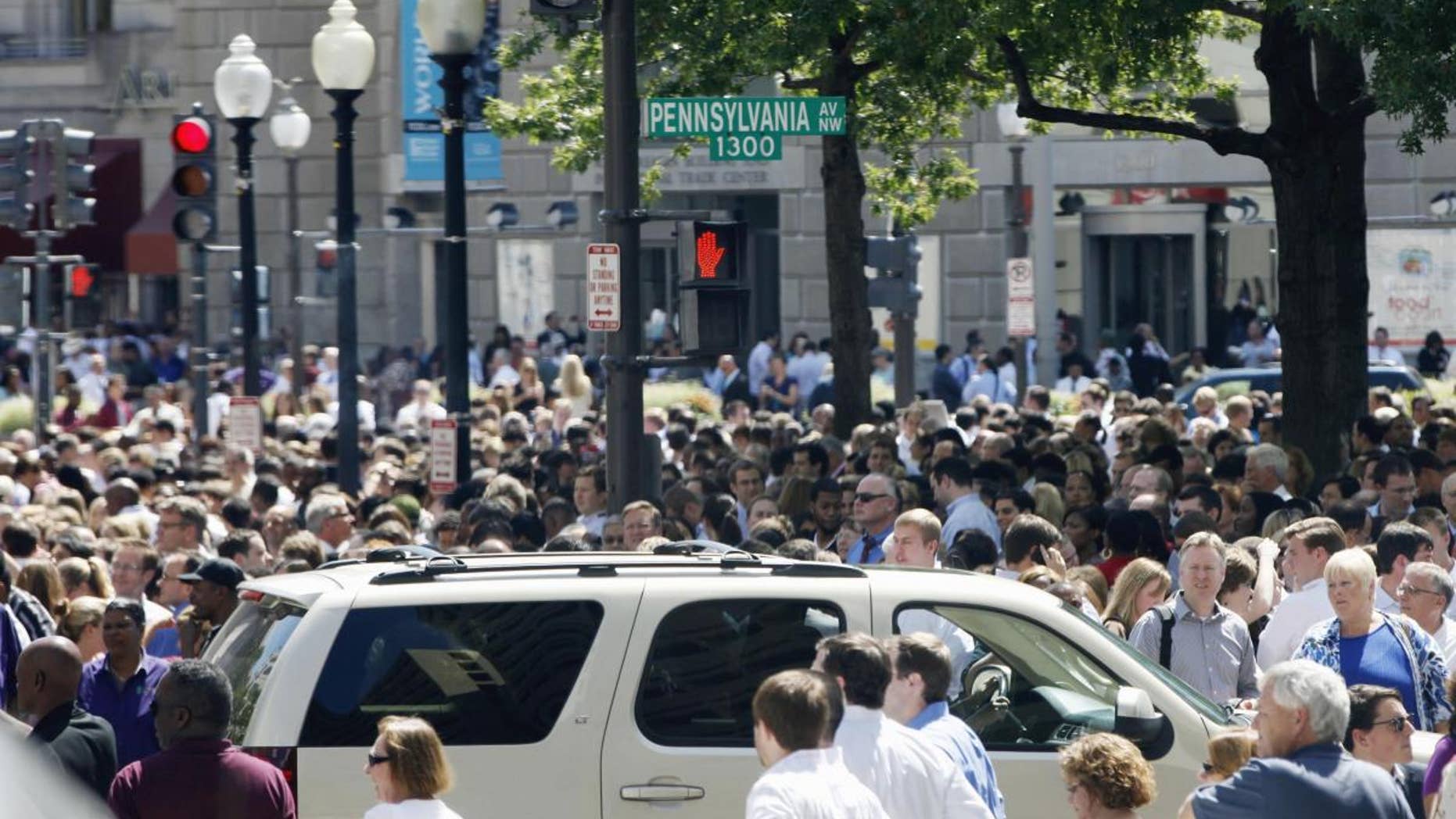 People crowd Pennsylvania Avenue in Washington, Tuesday, Aug. 23, 2011, as buildings were evacuated following an earthquake. (AP Photo/Charles Dharapak)