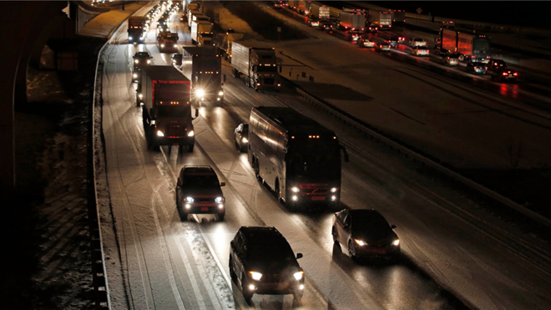 Traffic is bumper to bumper and mostly at a stand-still on the outer loop of the I-495 Capital Beltway after snow fell Wednesday, Jan. 20, 2016, in National Harbor, Md. As Washington prepares for this weekend's snowstorm, now forecast to reach blizzard conditions, a small clipper system pushed through the region Wednesday night causing massive delays and issues on the roads. (AP Photo/Alex Brandon)