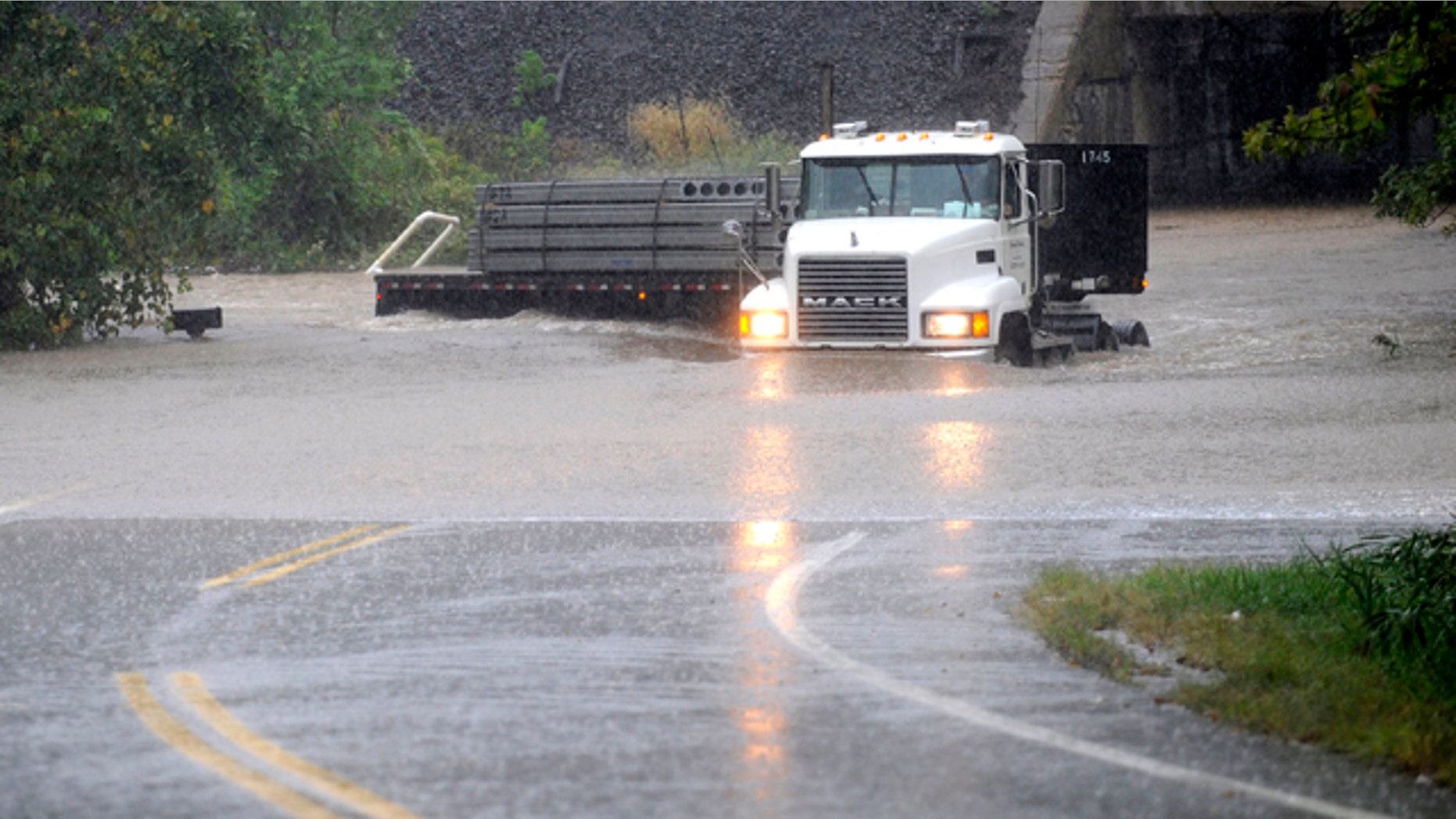Sept. 30, 2010: A truck makes its way through a rising Stemmers Run on Golden Ring Road in east Baltimore County, Md. A massive rainstorm drenched the East Coast from the Carolinas to Maine, washing out commutes and wiping away months of dry weather.