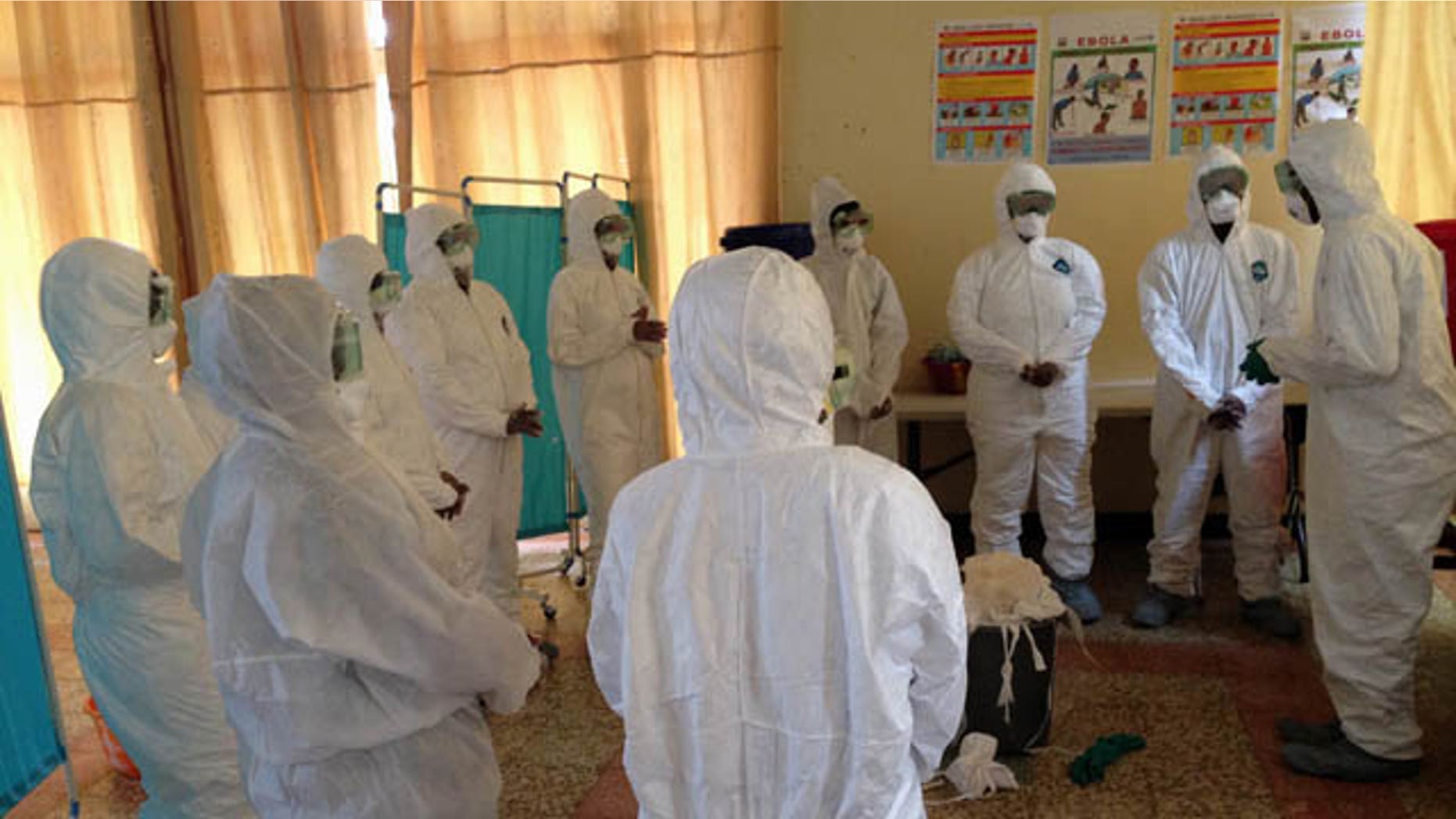 This photo provided by Dr. Dan Lucey, of the Georgetown University Medical Center, shows a session he supervised in Sierra Leone to train local health workers how to properly put on and take off equipment to protect against the Ebola virus. (AP Photo/Dan Lucey)