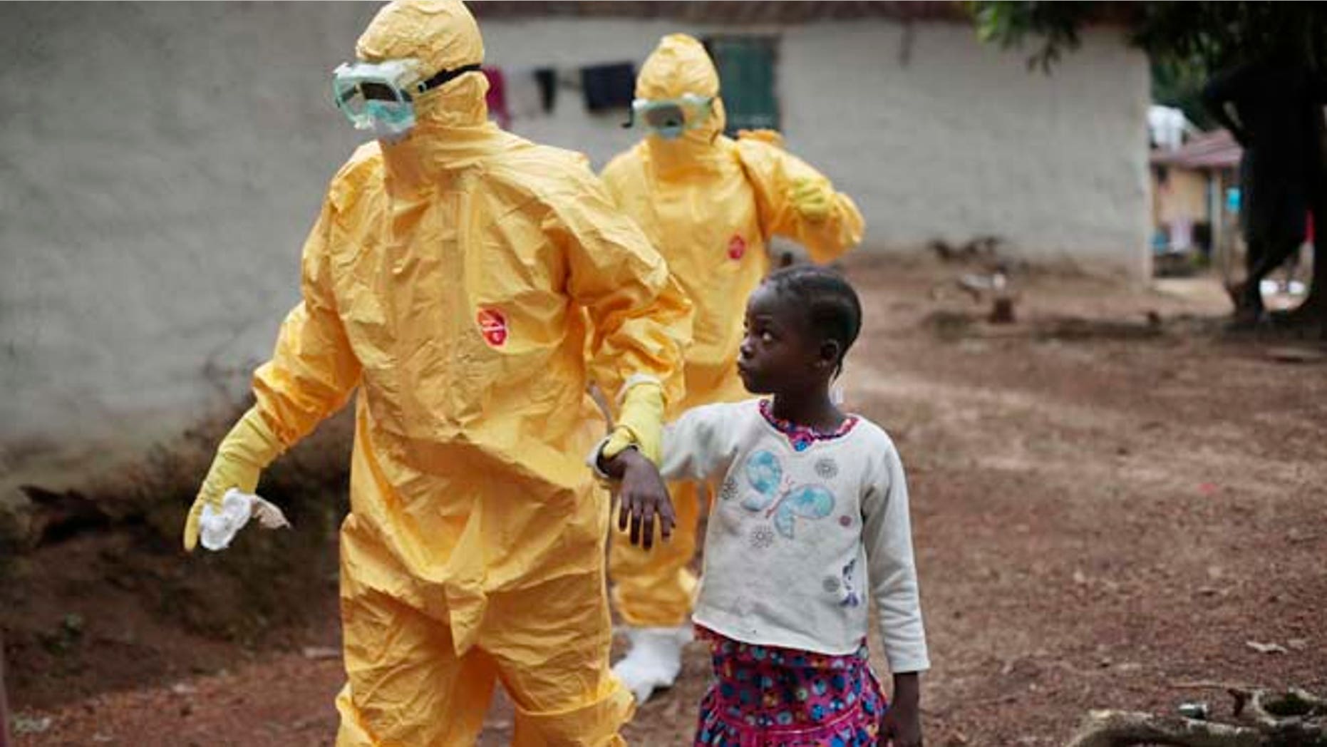 FILE 2014: Nine-year-old Nowa Paye is taken to an ambulance after showing signs of the Ebola virus disease in the village of Freeman Reserve, which is north of Monrovia, Liberia.
