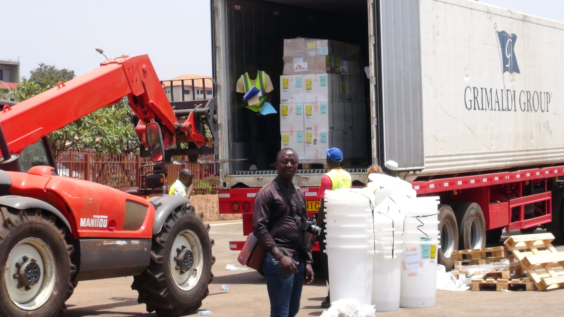 Workers from Doctors Without Borders unload emergency medical supplies to deal with an Ebola outbreak in Conakry, Guinea, March 23, 2014. (REUTERS/Saliou Samb)