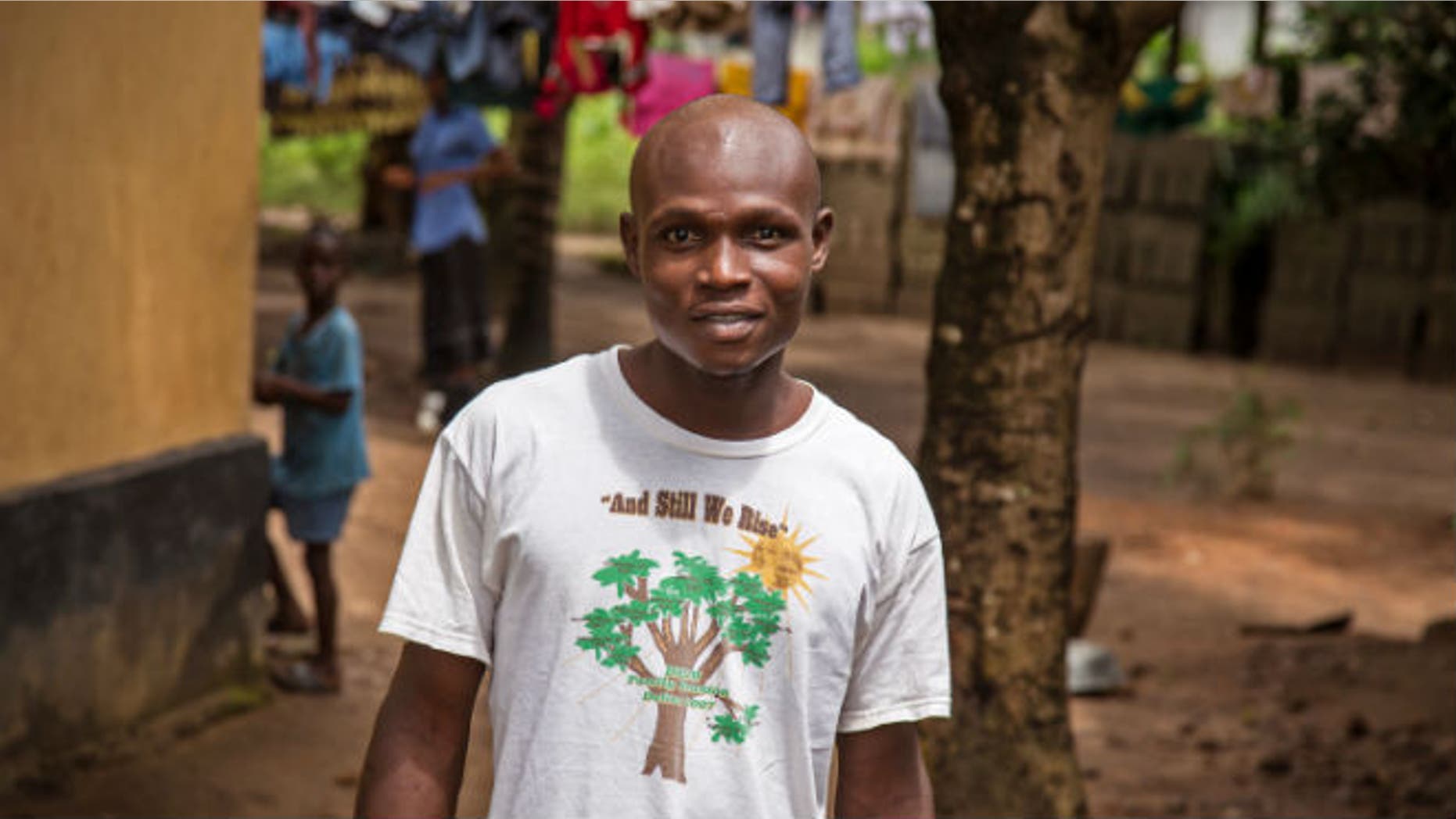 In this photo taken Monday, Aug. 11, 2014, Sulaiman Kemokai, an Ebola virus survivor near his house in the Heigbema Village in Kenema situated in the Eastern Province around 300km, (186 miles), from the capital city of Freetown in Kenema, Sierra Leone. (AP Photo/ Michael Duff)