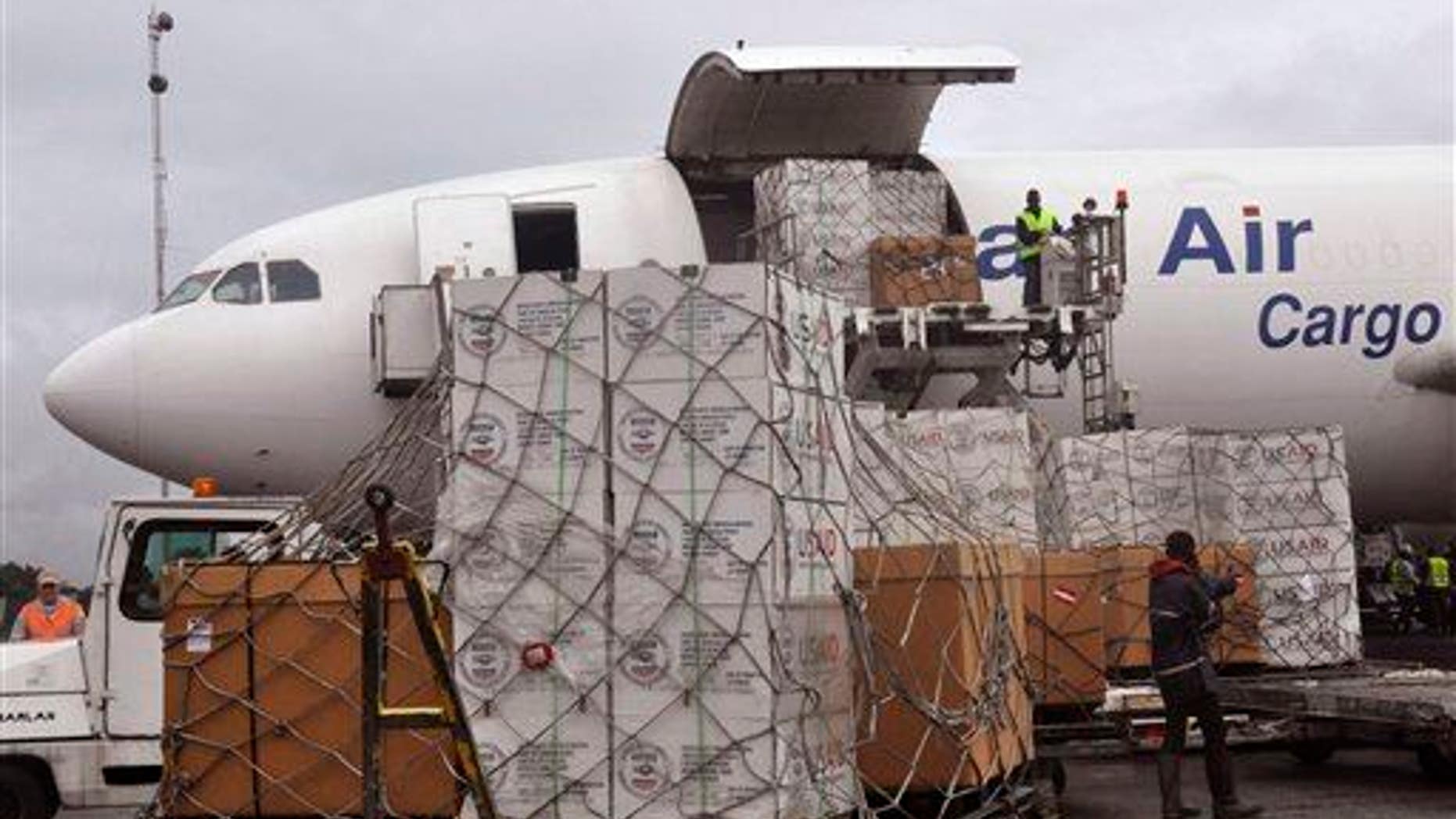 American Aid goods are offloaded from an airplane, to be used in the fight against the Ebola virus spreading in the city of Monrovia, Liberia, Sunday, Aug. 24, 2014.
