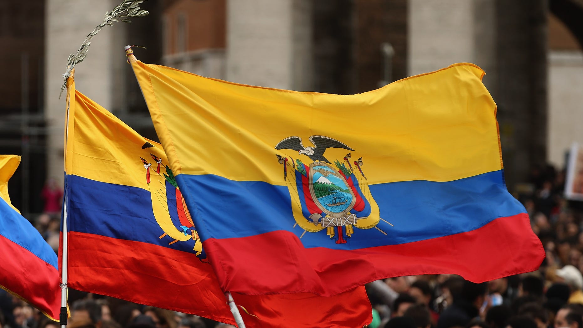 VATICAN CITY, VATICAN - MARCH 17: The flag of Ecuador is held as people gather in St Peter's Square ahead of the arrival of Pope Francis who will give his first Angelus Blessing to the faithful from the window of his private residence on March 17, 2013 in Vatican City, Vatican. The Vatican is preparing for the inauguration of Pope Francis on March 19, 2013 in St Peter's Square. (Photo by Dan Kitwood/Getty Images)